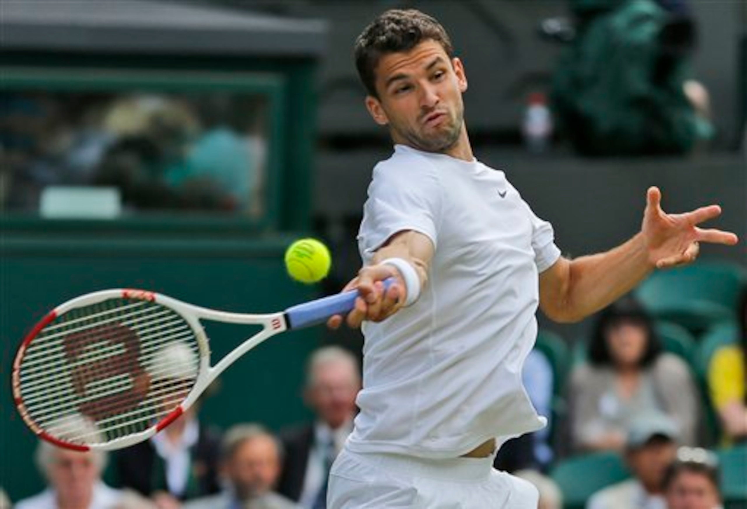 Grigor Dimitrov hits a forehand during a match at Wimbledon.