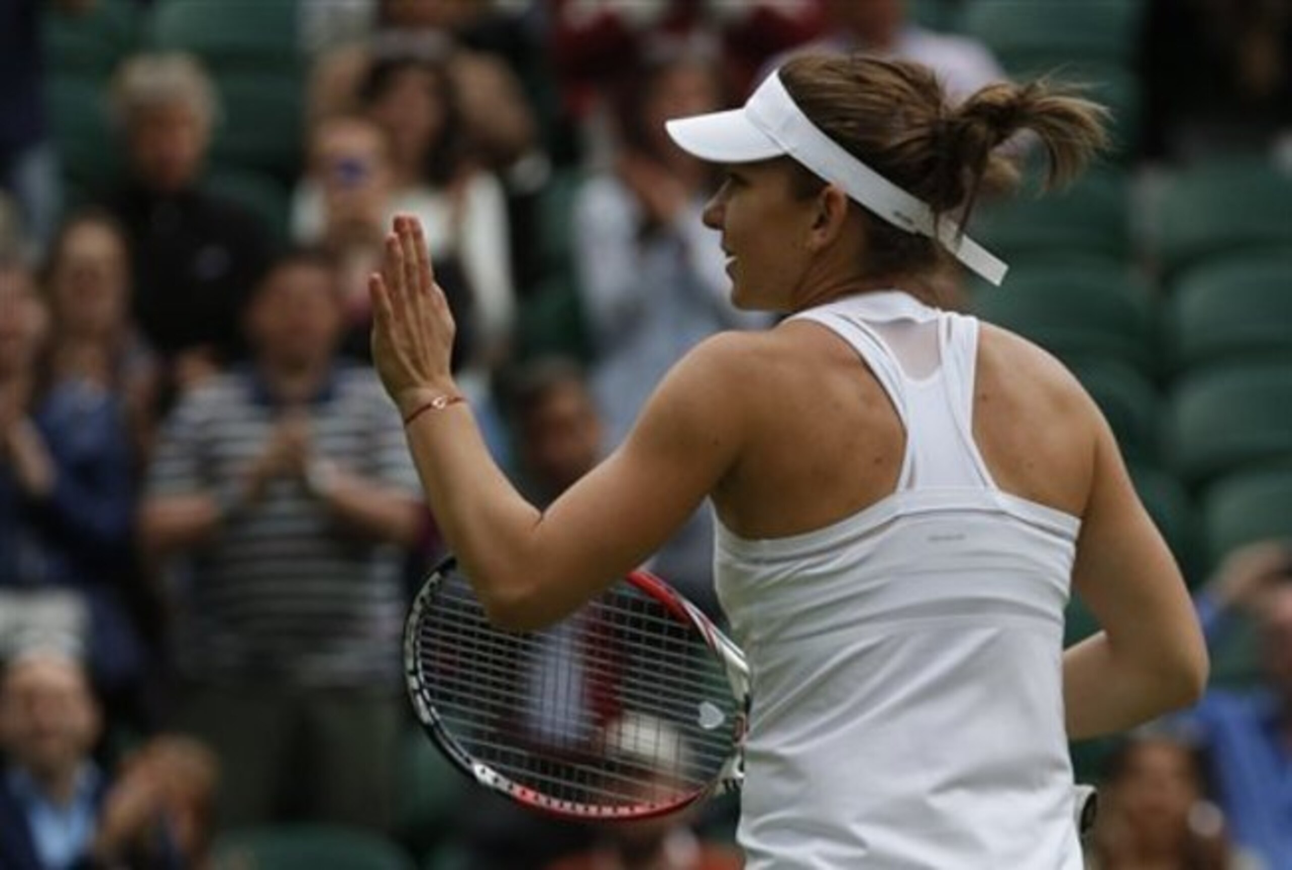 Simona Halep waves to the crowd after winning her first-round match.