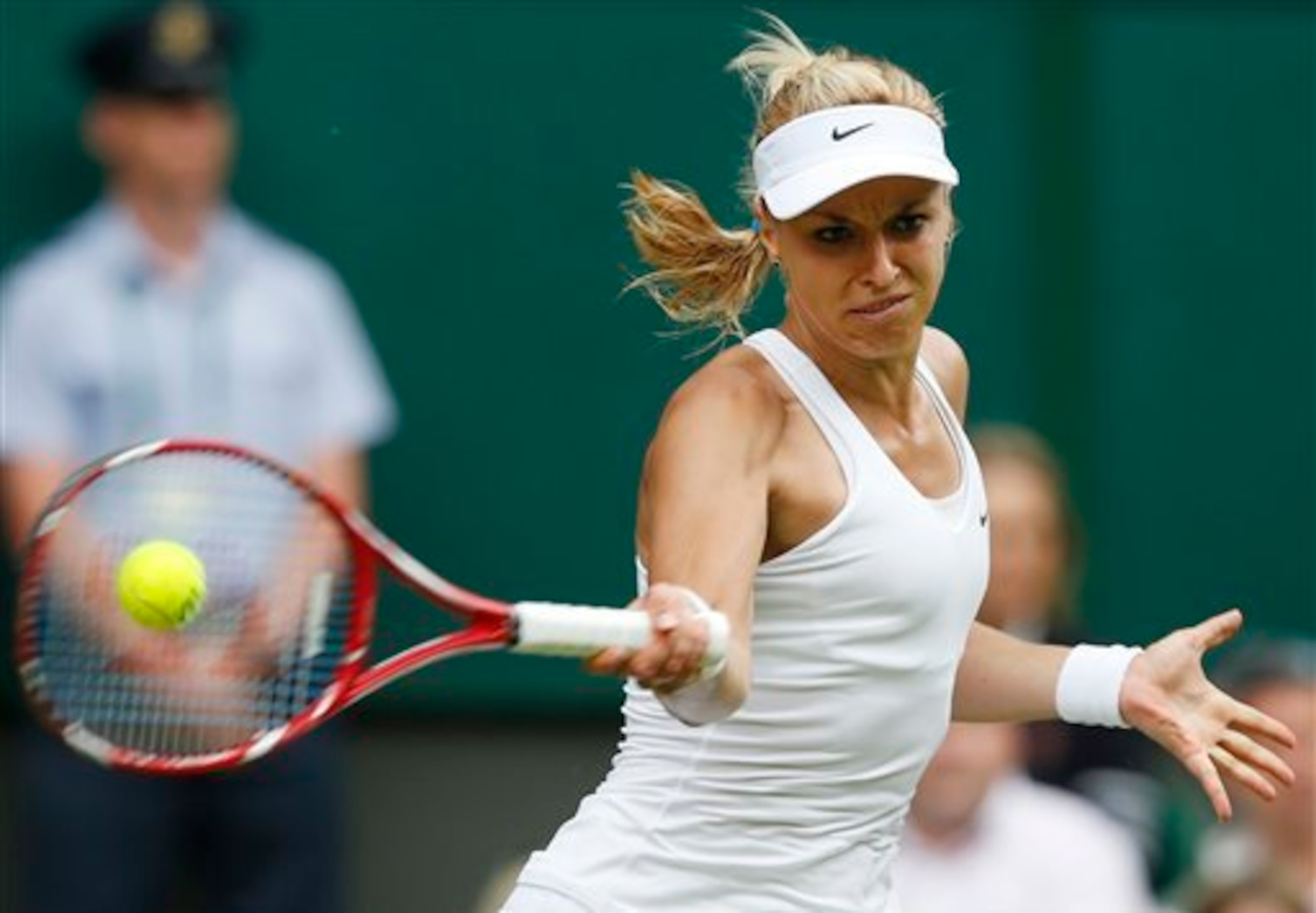 Sabine Lisicki hits a forehand during a match in the first week of the 2014 Championships, Wimbledon.