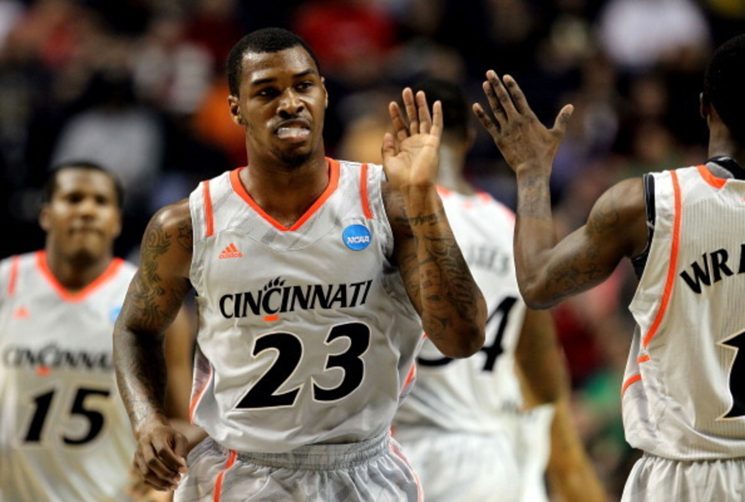 Cincinnati guard Sean Kilpatrick high-fives a teammate.