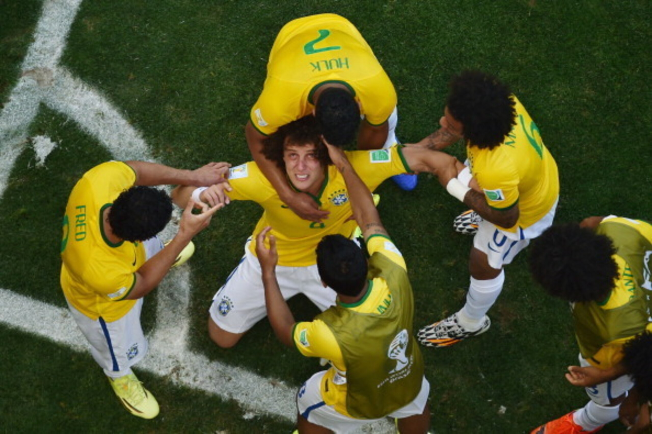 Paulinho (bottom of screen) celebrates with his team-mates after David Luiz scored Brazil's opener.