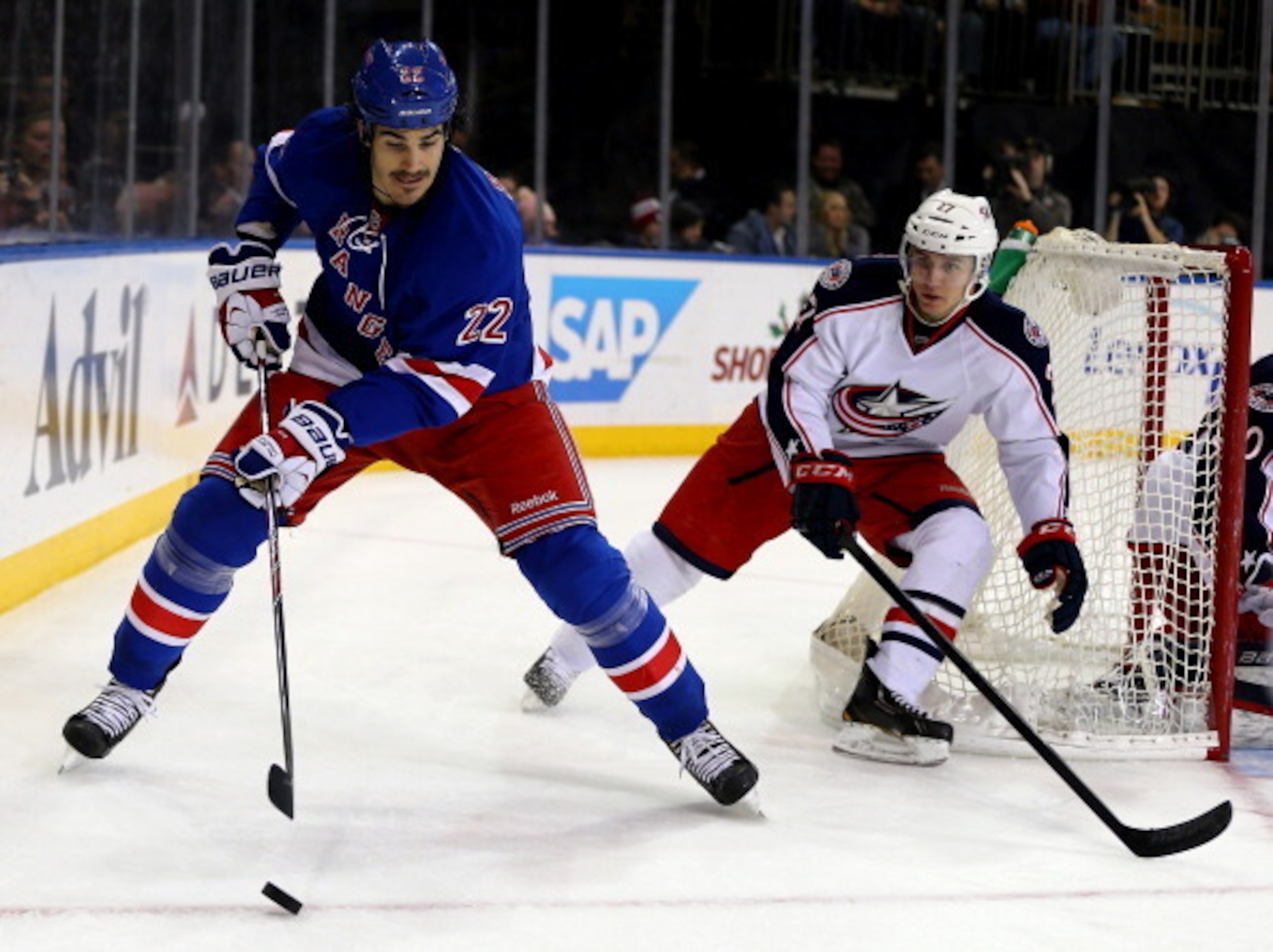 Mustache-touting Brian Boyle protects the puck deep in the Rangers' attacking zone in 2013-14.