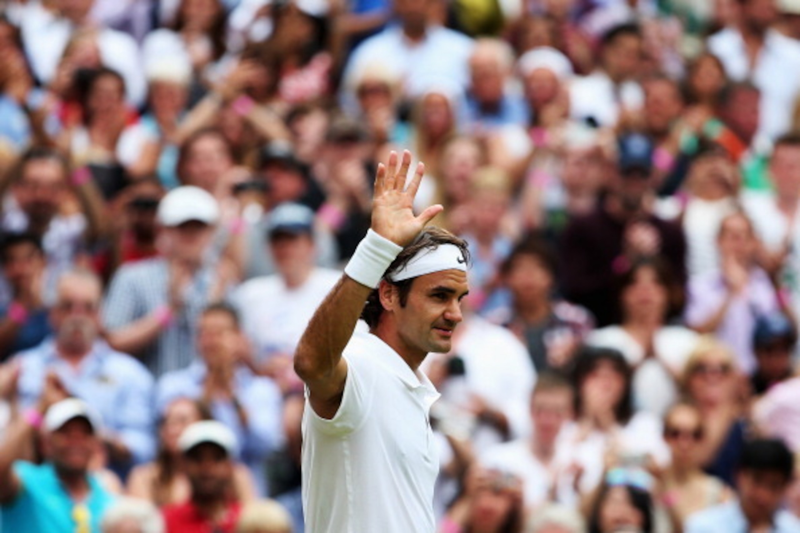 Roger Federer waves to the crowd after winning his quarterfinal match.