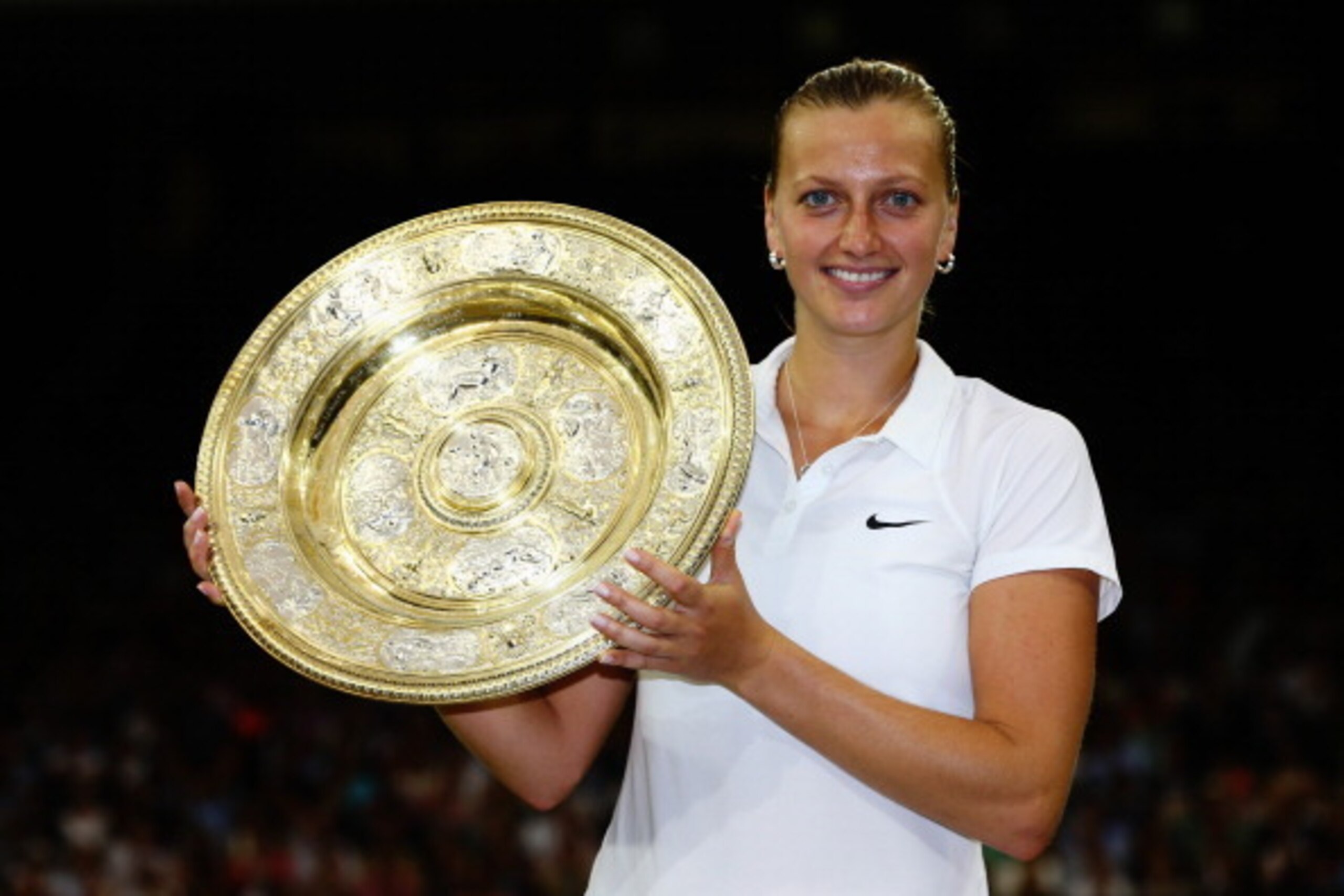 Petra Kvitova holds up the Venus Rosewater Dish after winning her second Wimbledon title.