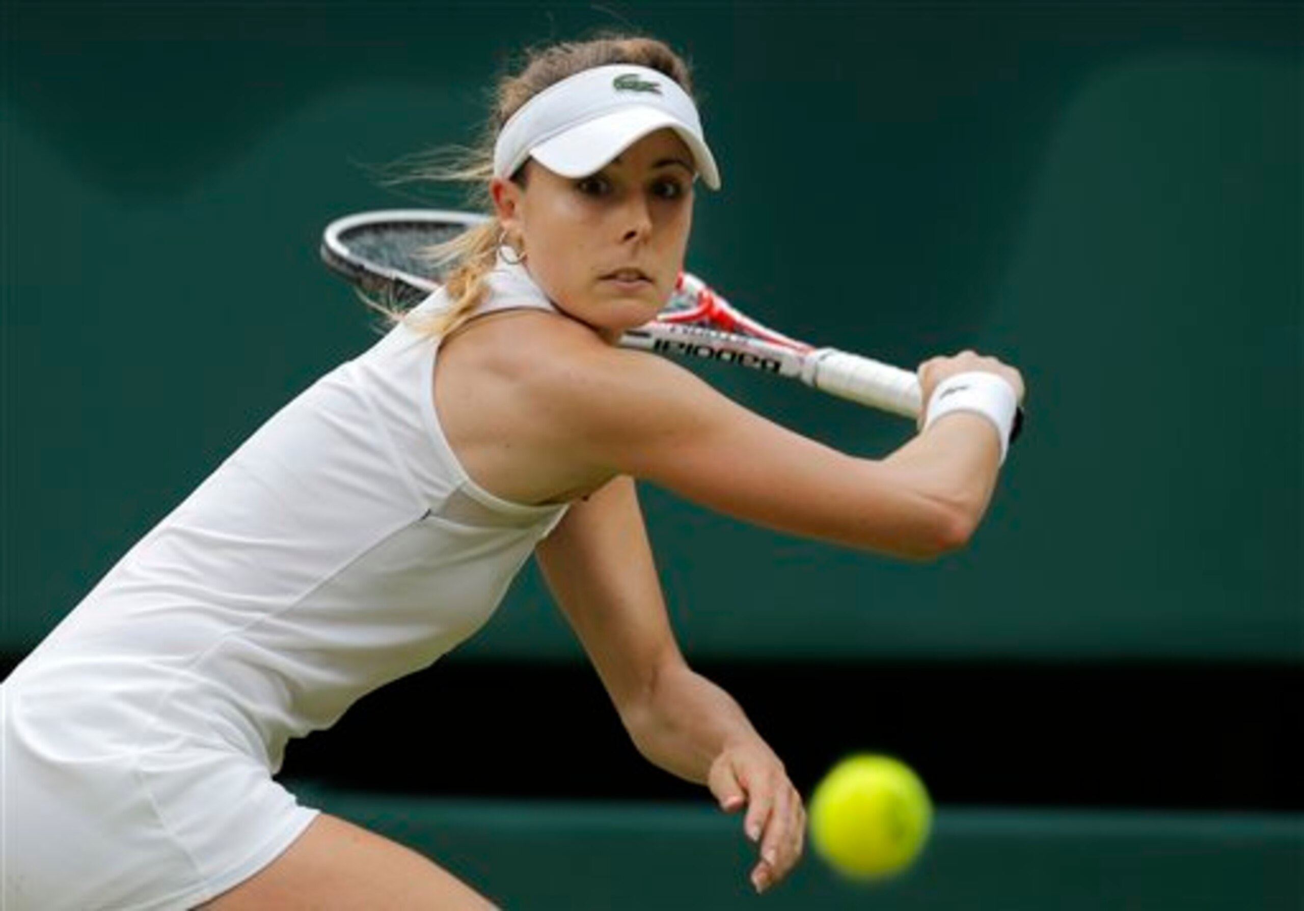 Alize Cornet readies to unleash her slice backhand during her fourth-round match at Wimbledon.