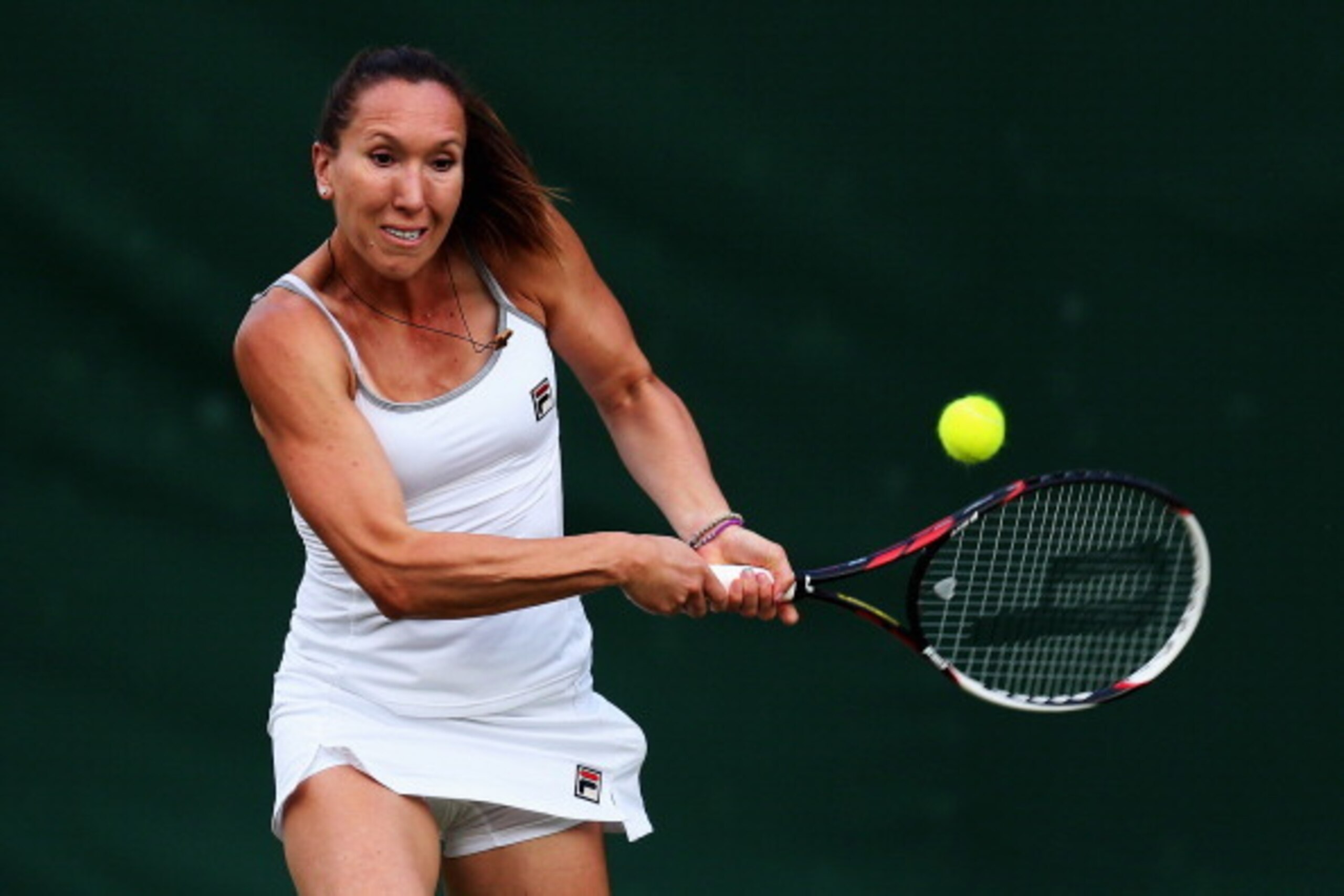 Jelena Jankovic hits a backhand during a doubles match at Wimbledon.