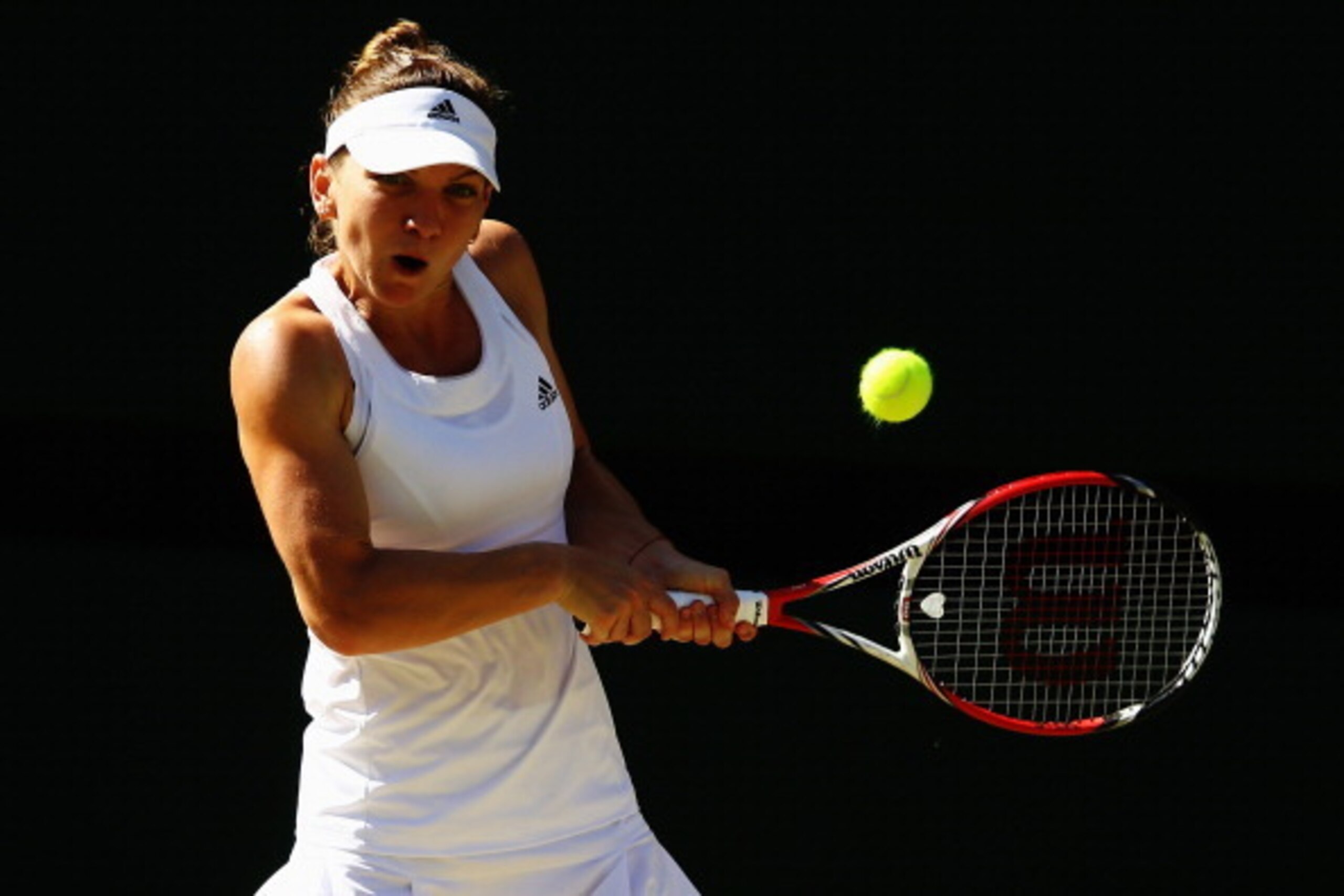 Simona Halep hits a backhand during her semifinal match at Wimbledon.