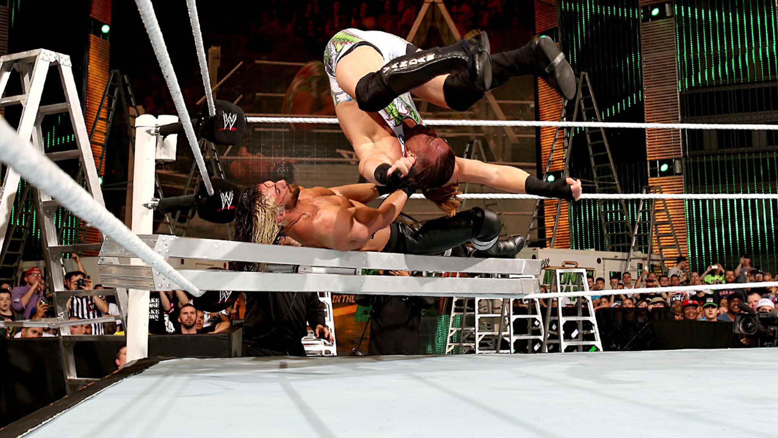 Rob Van Dam hits Rolling Thunder onto Seth Rollins.