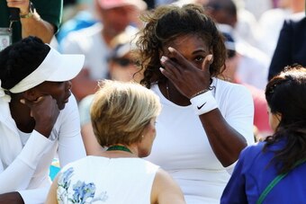 Serena Williams gets a visit from the Wimbledon medical team during a doubles match.