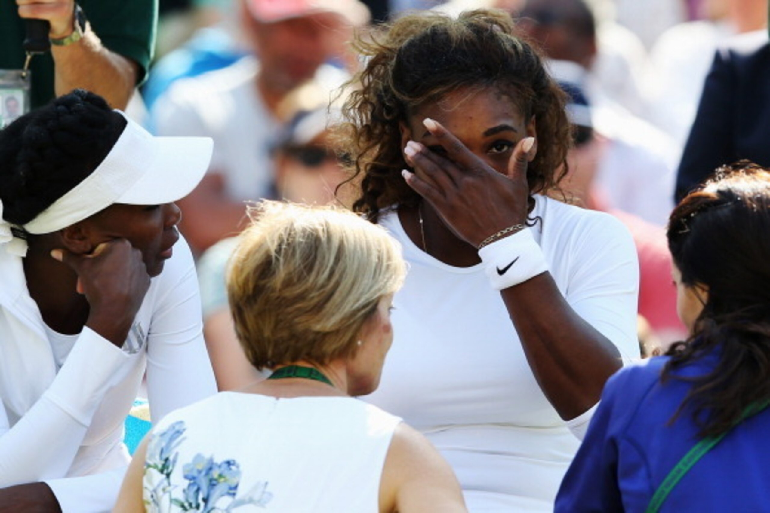 Serena Williams gets a visit from the Wimbledon medical team during a doubles match.