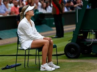 Eugenie Bouchard sits and waits for the trophy presentation ceremony at Wimbledon.