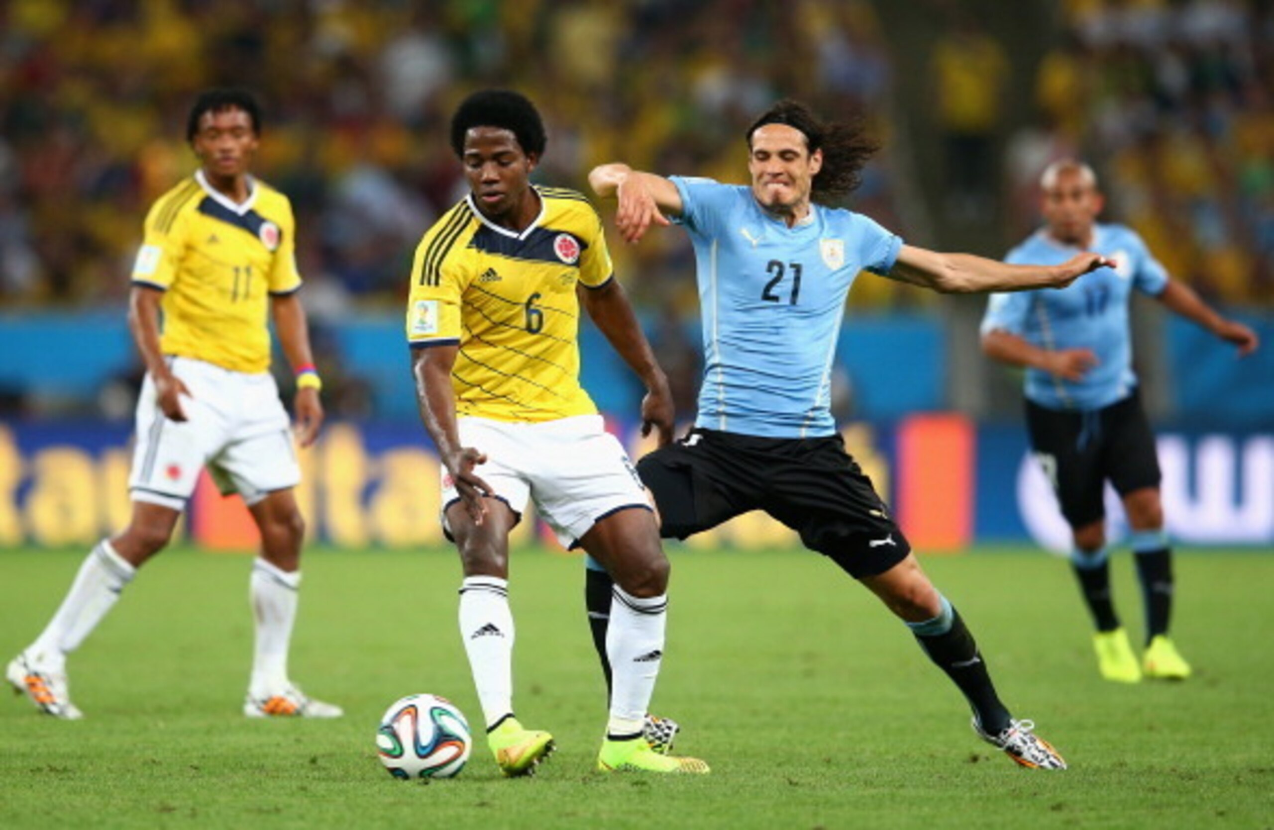 Carlos Sanchez holds off Uruguay's Edinson Cavani