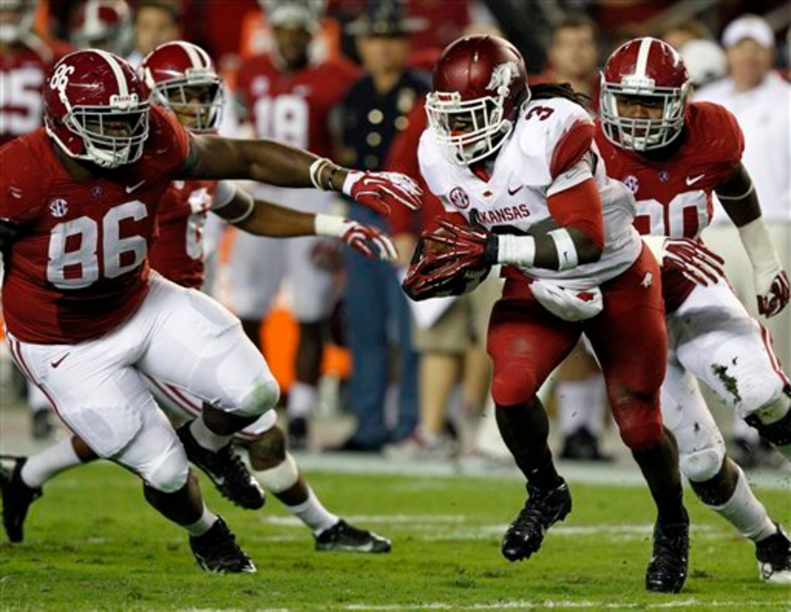 Alex Collins looks for room against Alabama. Alex Collins looks for room against Alabama.