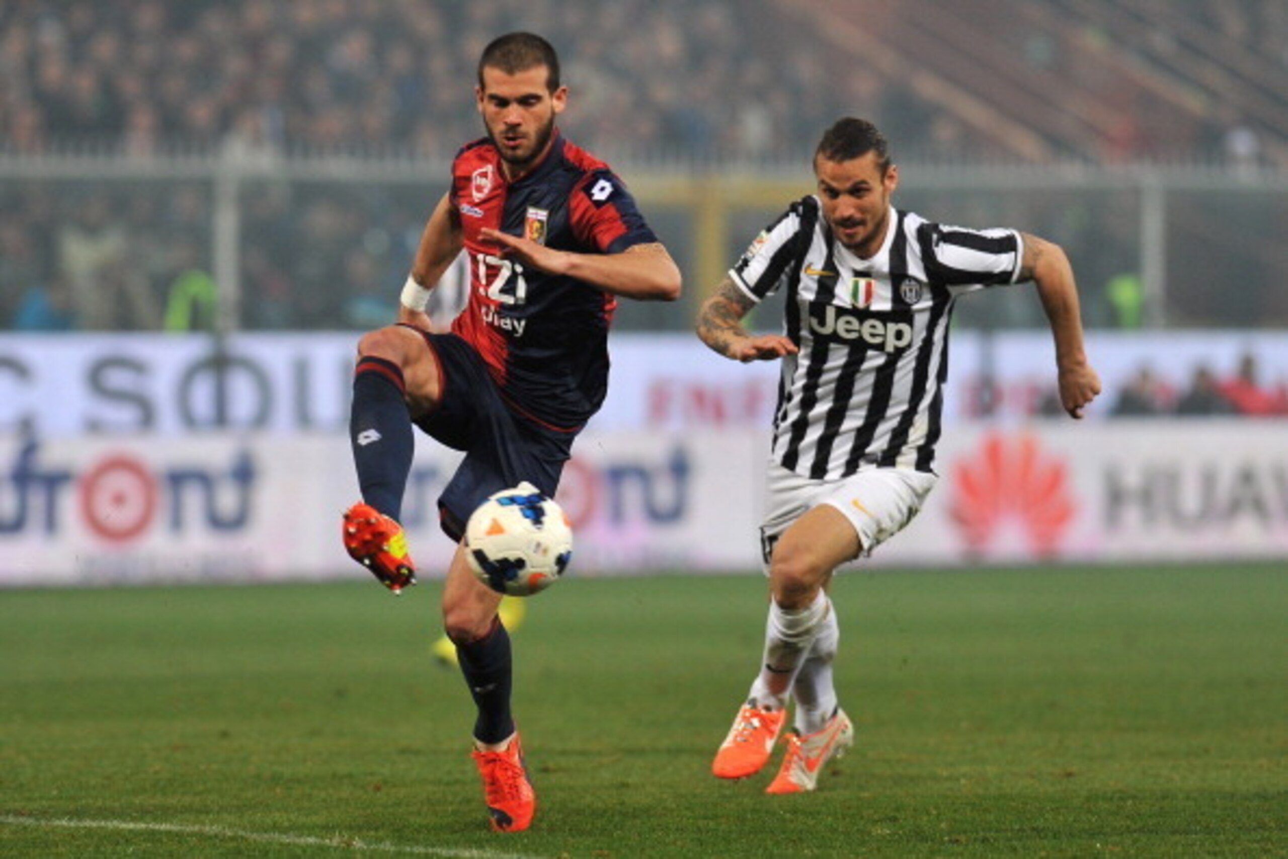 Stefano Sturaro controls the ball as Dani Osvaldo approaches to challenge.