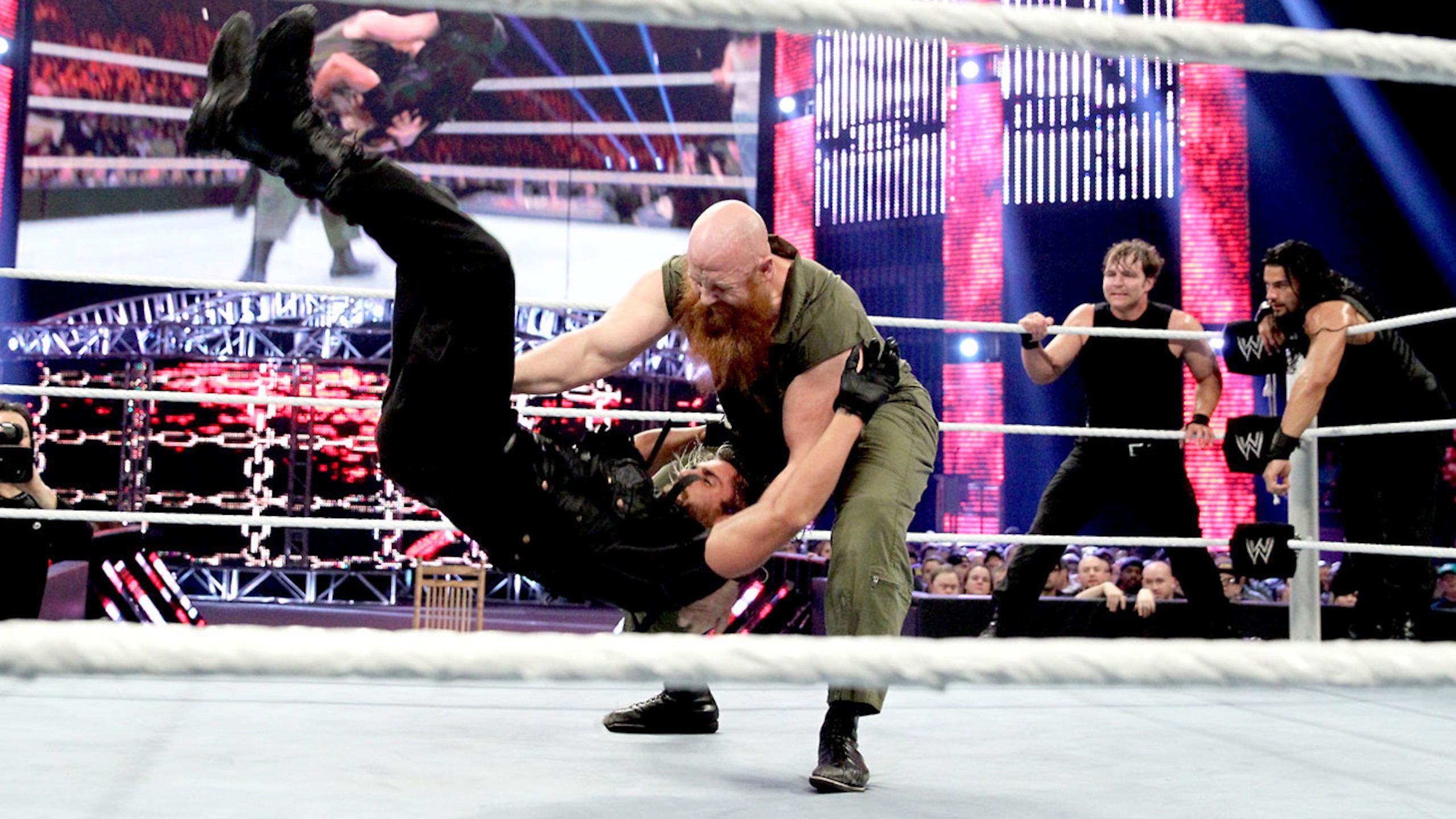 Erick Rowan sends Seth Rollins to the mat.