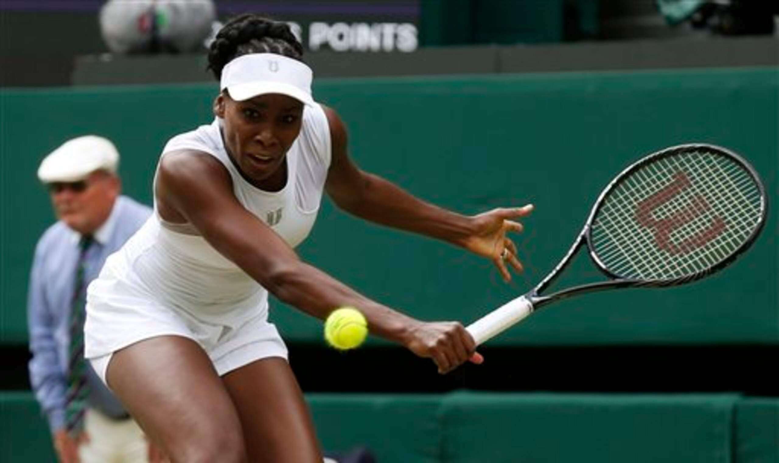 Venus Williams prepares to hit a backhand volley during a third-round match at Wimbledon.