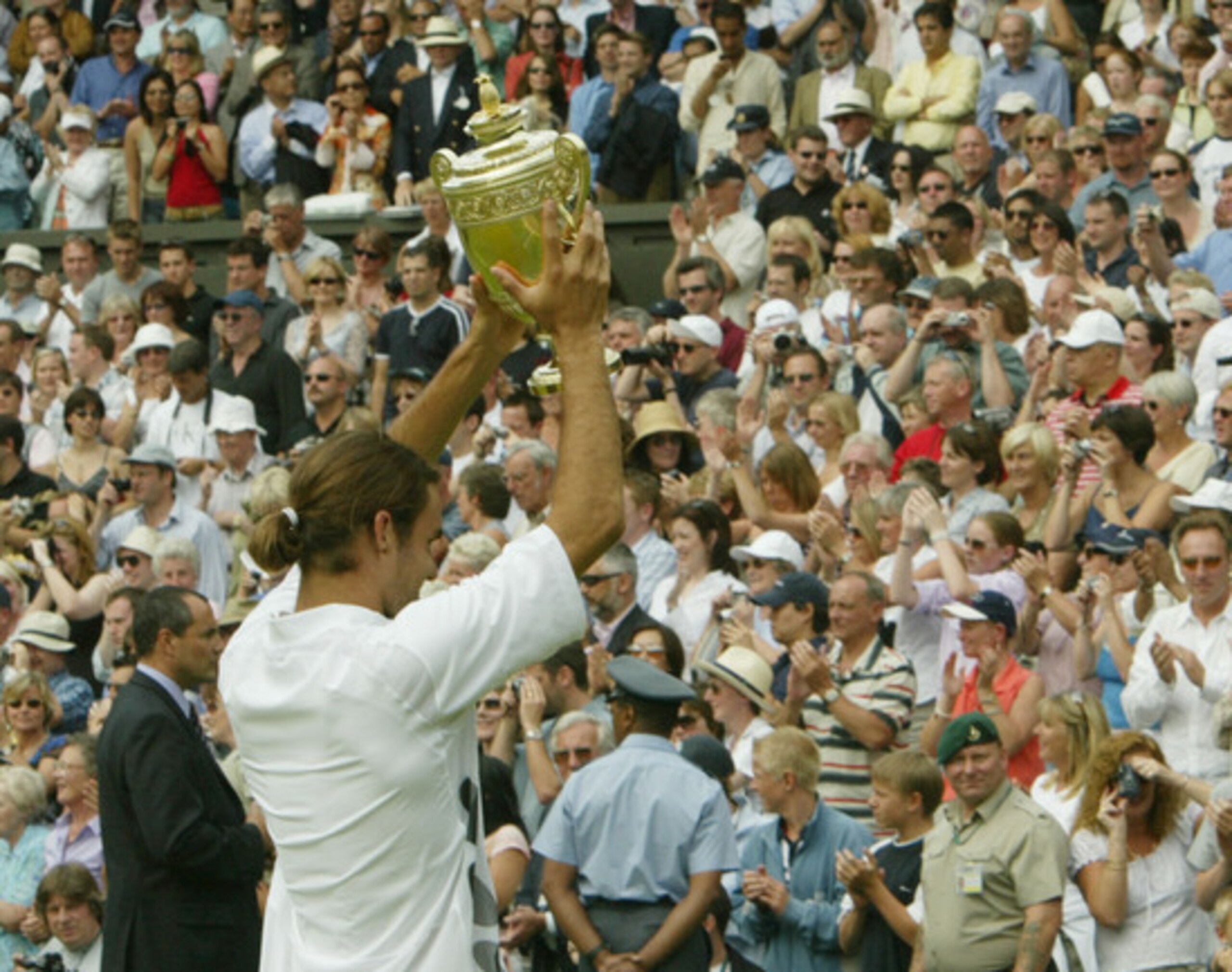 Federer wins his first career Grand Slam at Wimbledon in 2003