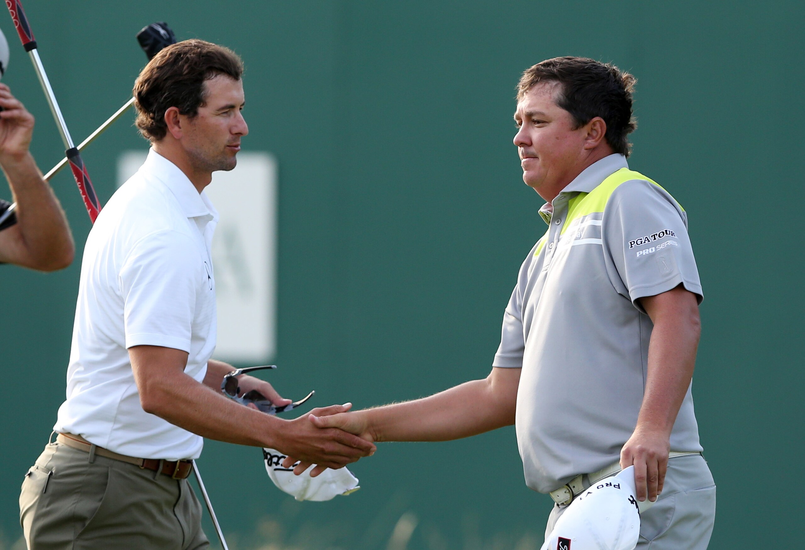 Adam Scott and Jason Dufner exchange handshakes after the first round.