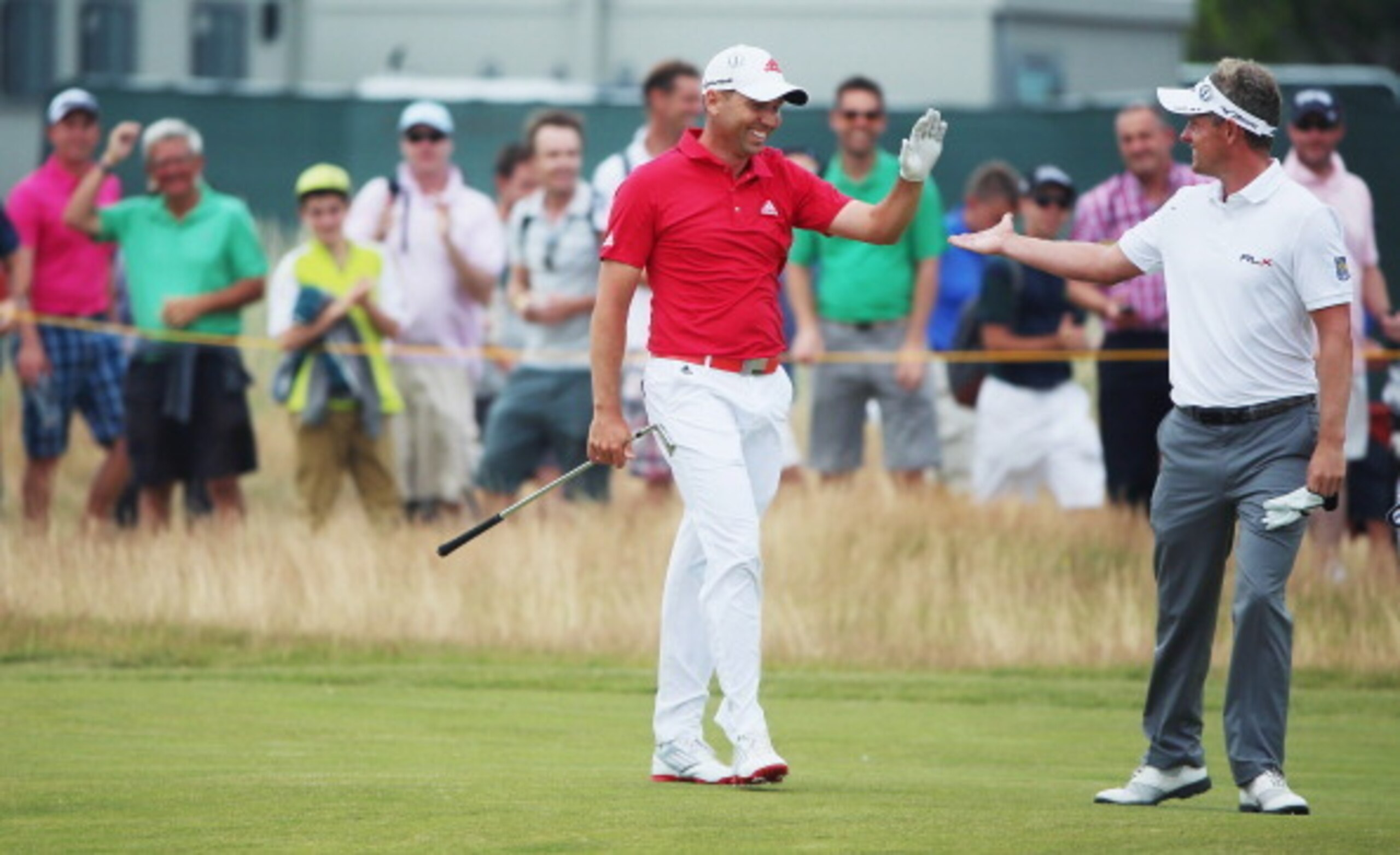 Sergio Garcia gets congrats from Luke Donald after holing his approach shot on No. 2 for an eagle.