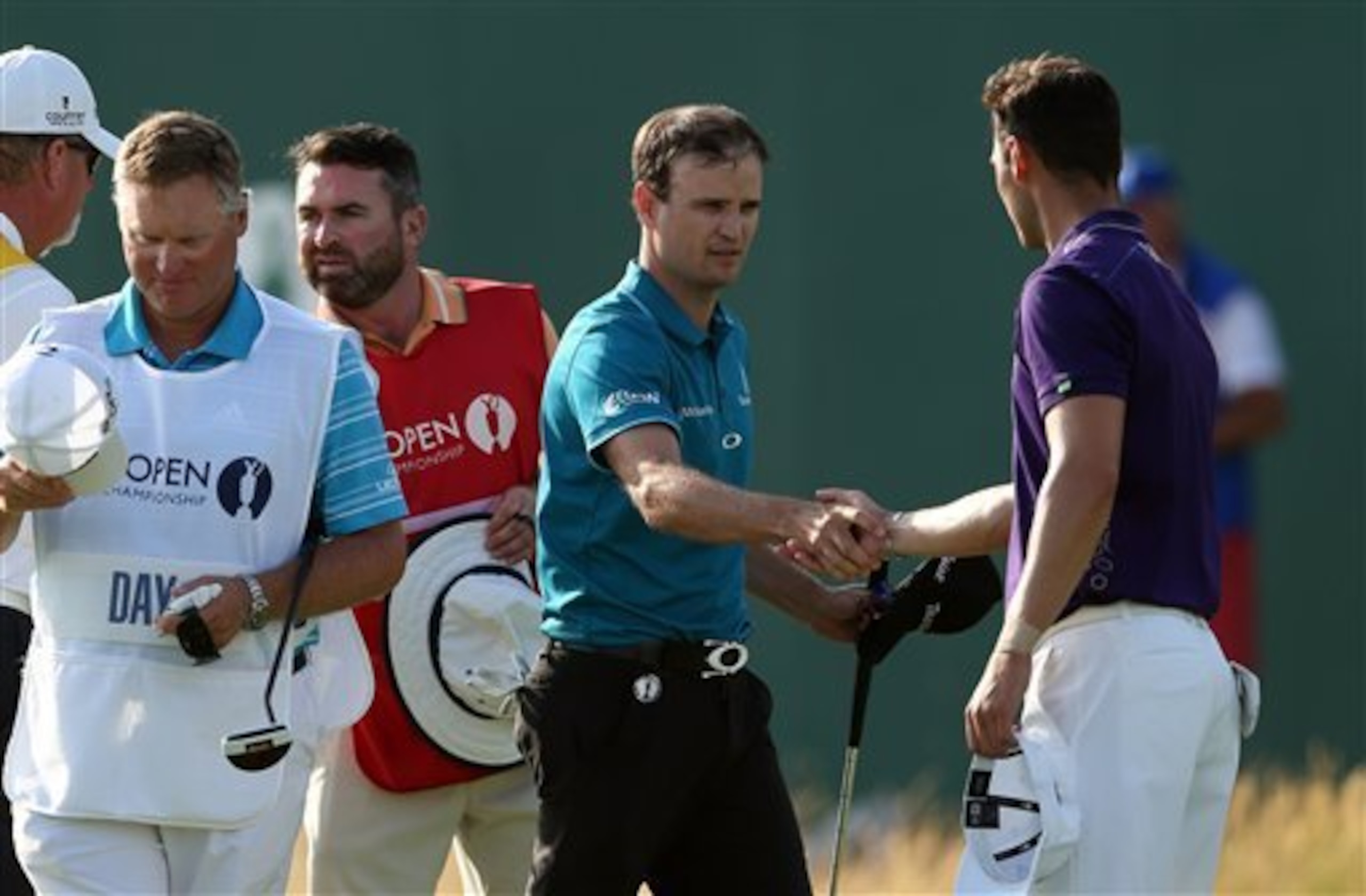 Zach Johnson and Martin Kaymer exchange handshakes at Royal Liverpool.