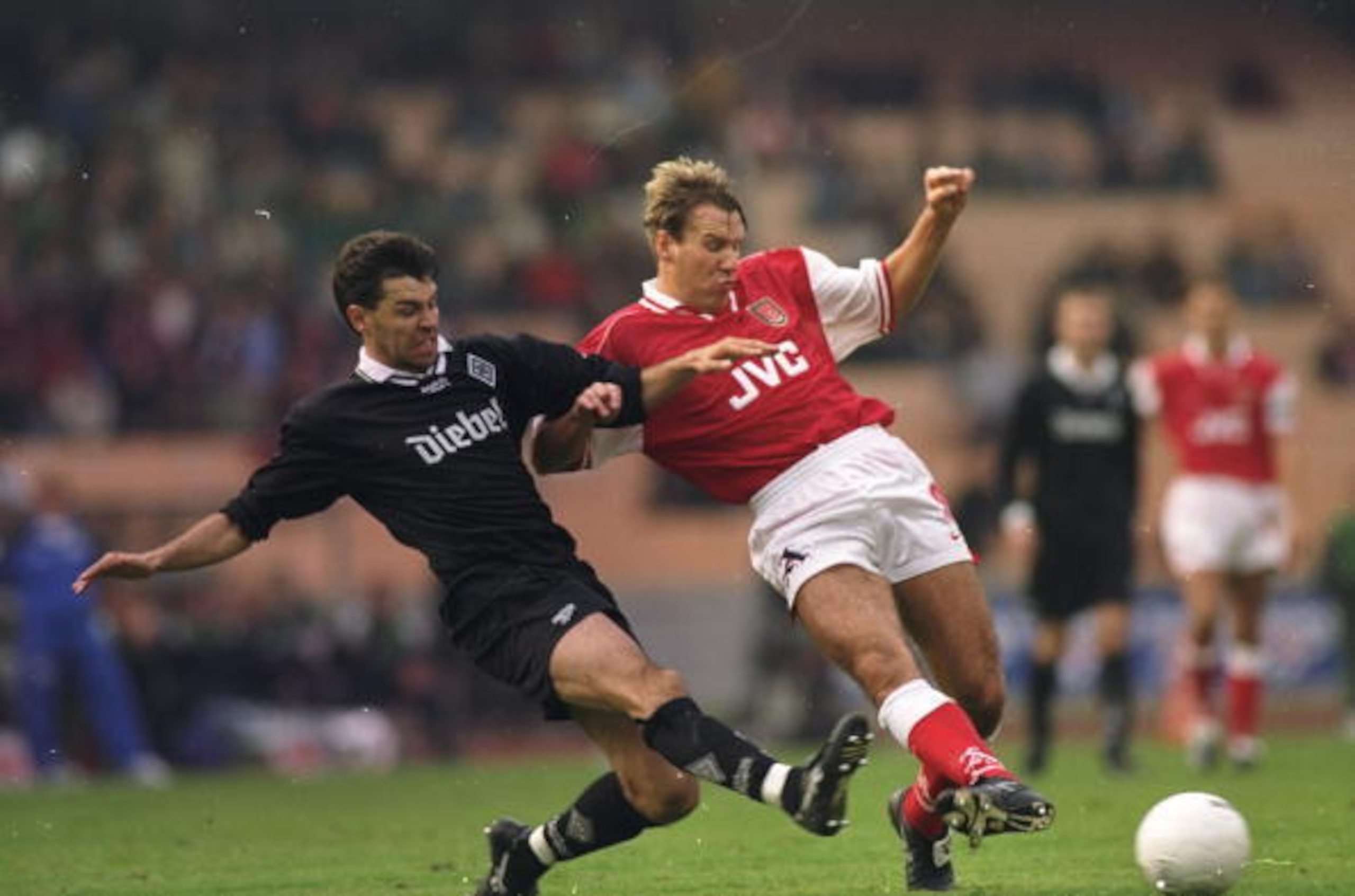 A very old photo of Hubert Fournier in his playing days tackling Paul Merson.