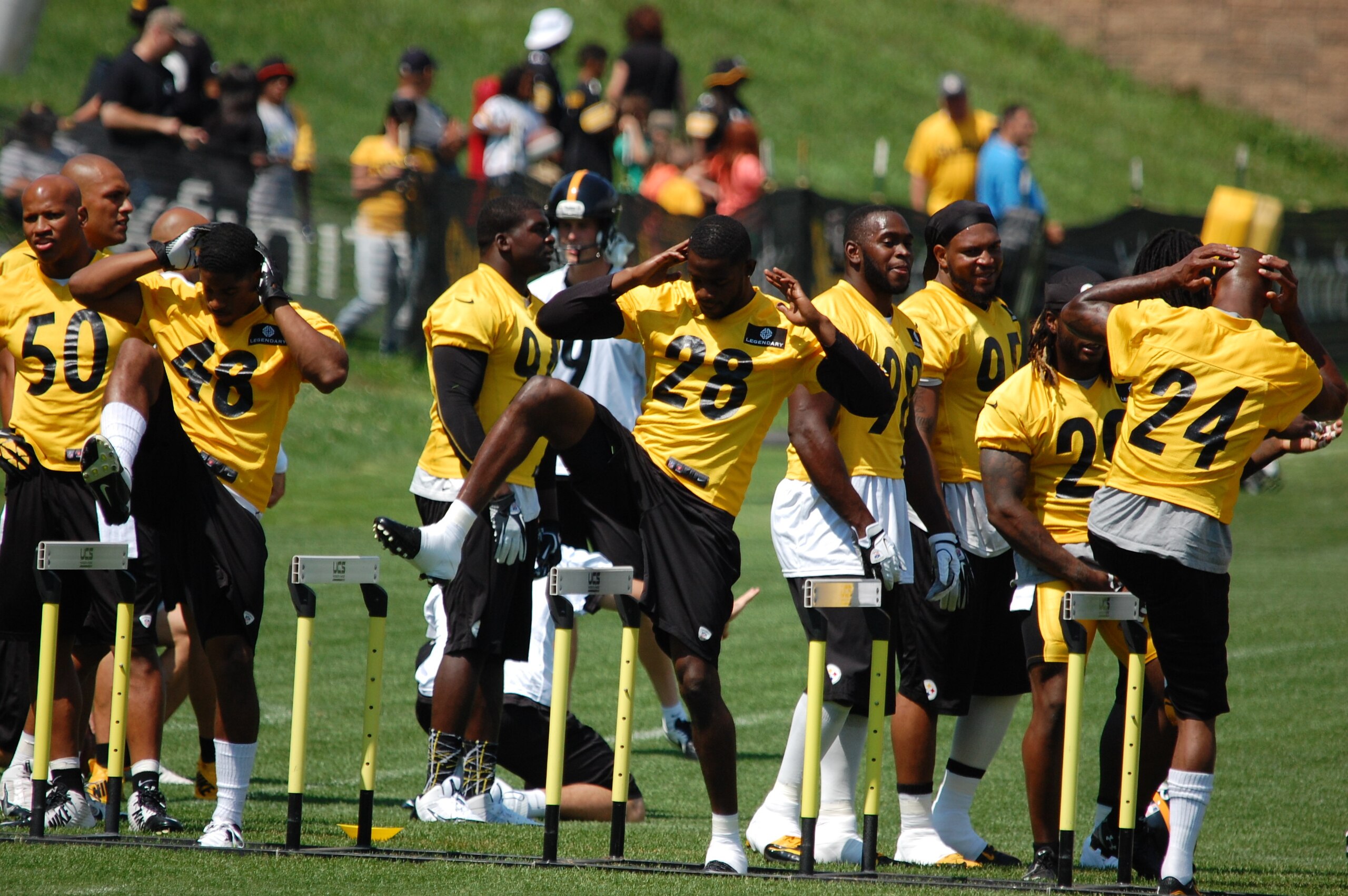 Linebackers and cornerbacks spent time stretching using hurdles.