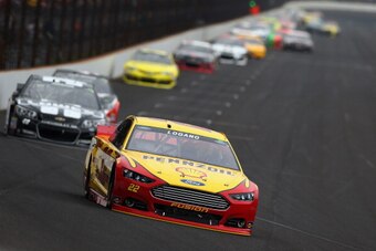 Joey Logano leads the 2014 Brickyard 400 field into Turn 1.