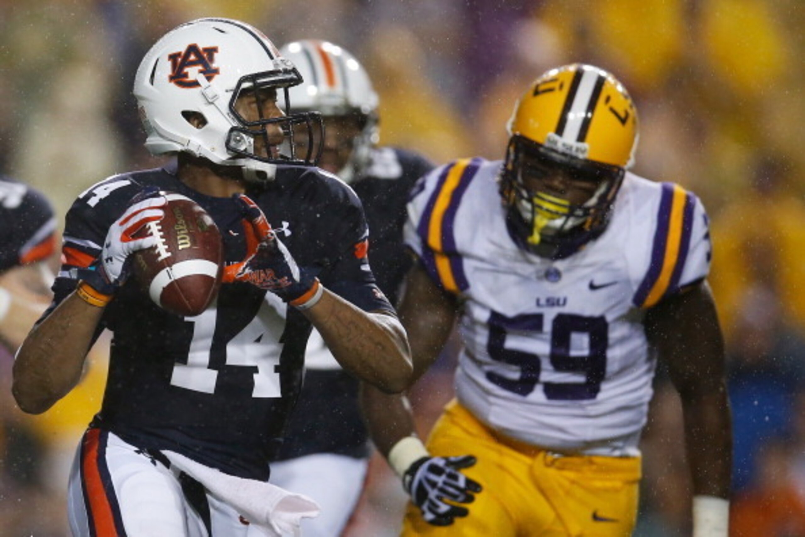 Auburn quarterback Nick Marshall gets chased down by LSU defensive end Jermauria Rasco.
