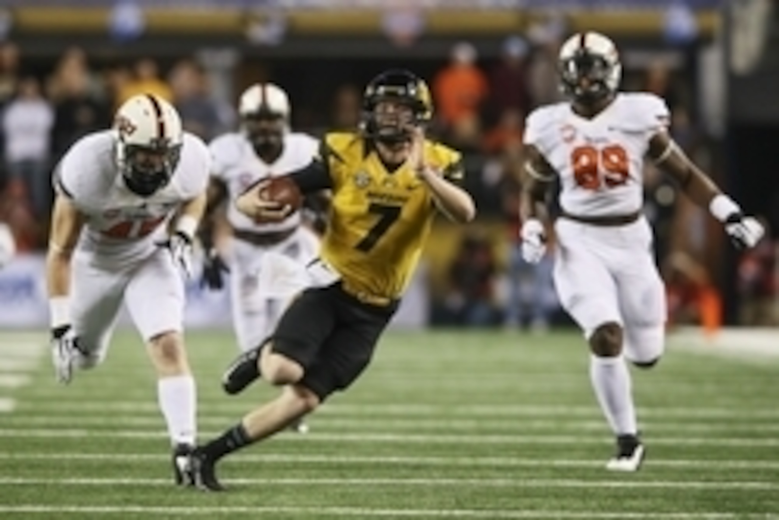 Jan 3, 2014; Arlington, TX, USA; Missouri Tigers quarterback Maty Mauk (7) runs away from Oklahoma State Cowboys defensive end Sam Wren (89) during the first half  in the 2014 Cotton Bowl at AT&T Stadium. Mandatory Credit: Kevin Jairaj-USA TODAY Sports