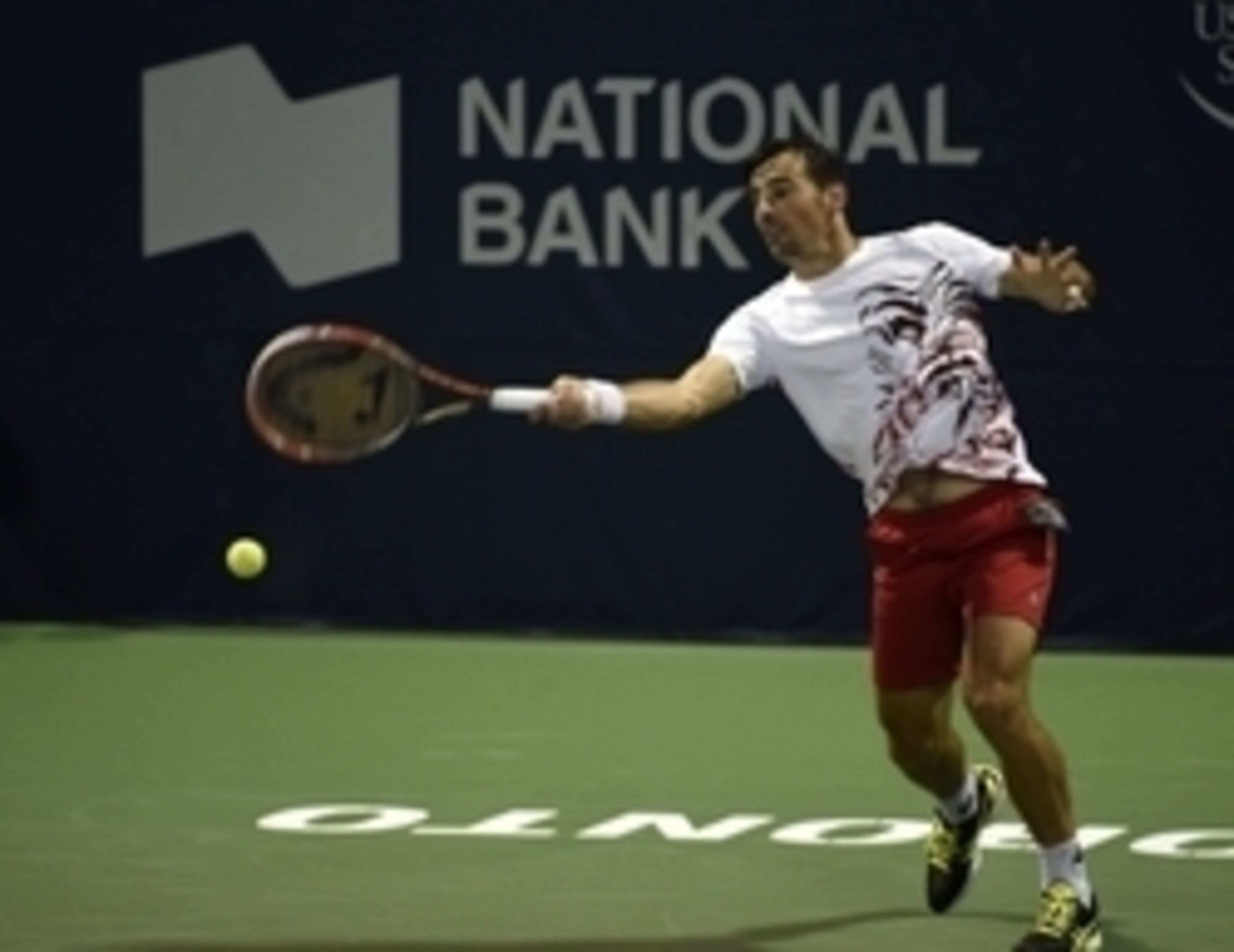 Ivan Dodig hits a forehand at Rogers Cup.