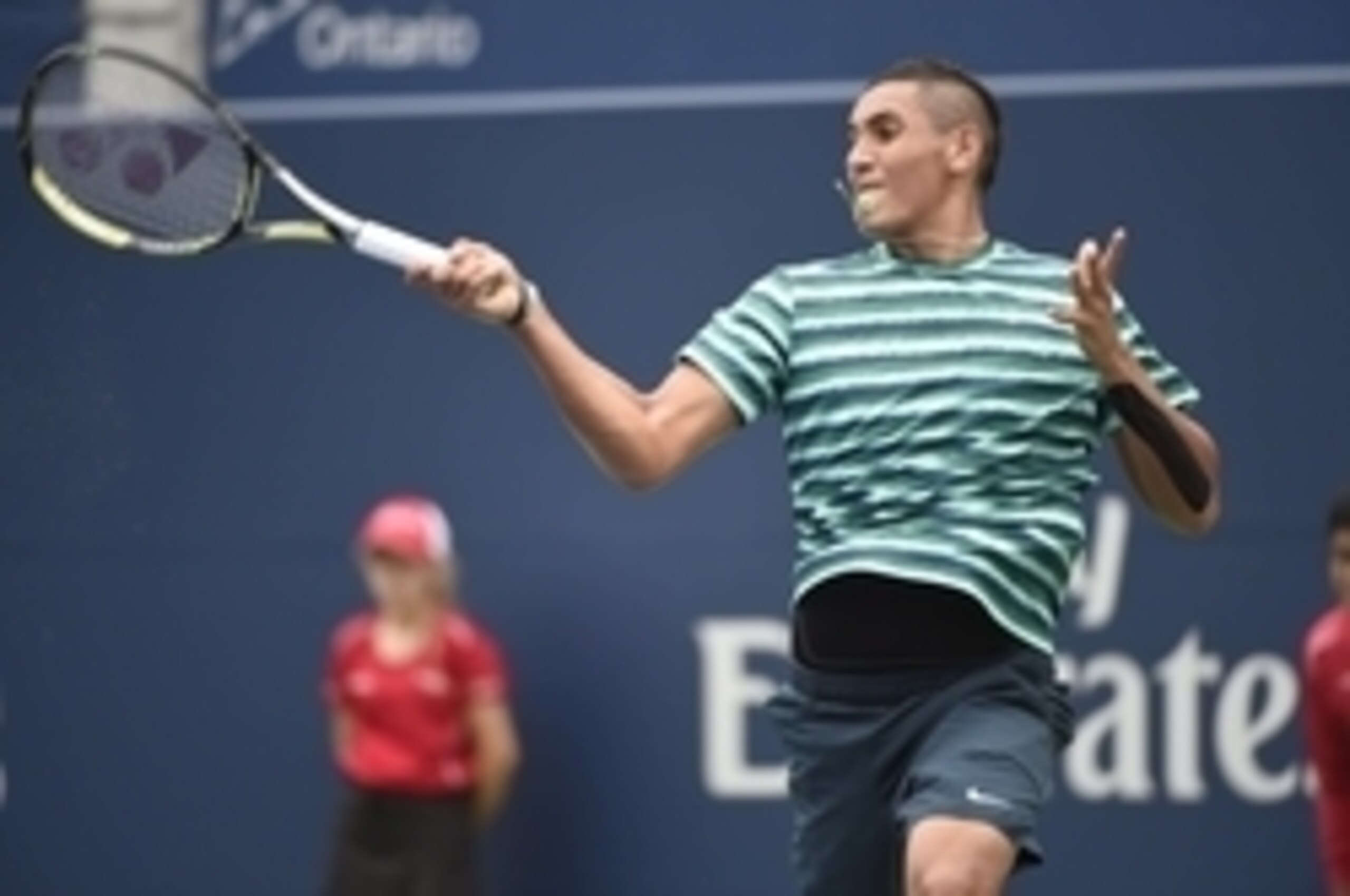 Nick Kyrgios hits a forehand during a 2014 Rogers Cup match.