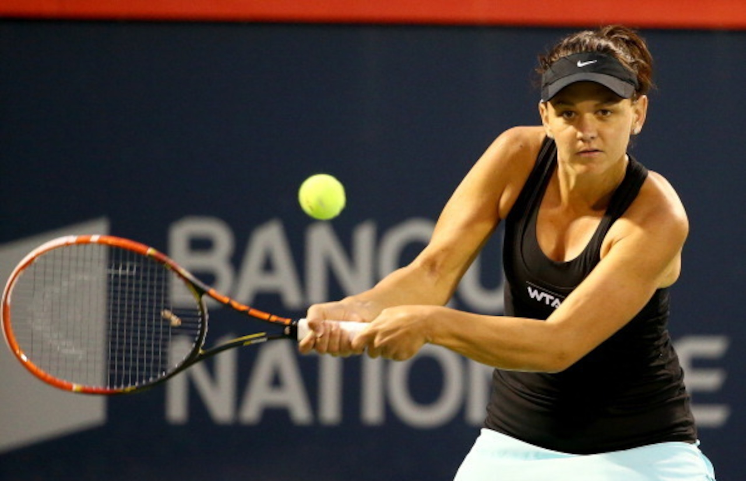 MONTREAL, QC - AUGUST 06:  Casey Dellacqua of Australia returns a shot against Petra Kvitova of the Czech Republic during the Rogers Cup at Uniprix Stadium on August 6, 2014 in Montreal, Canada.  (Photo by Streeter Lecka/Getty Images)