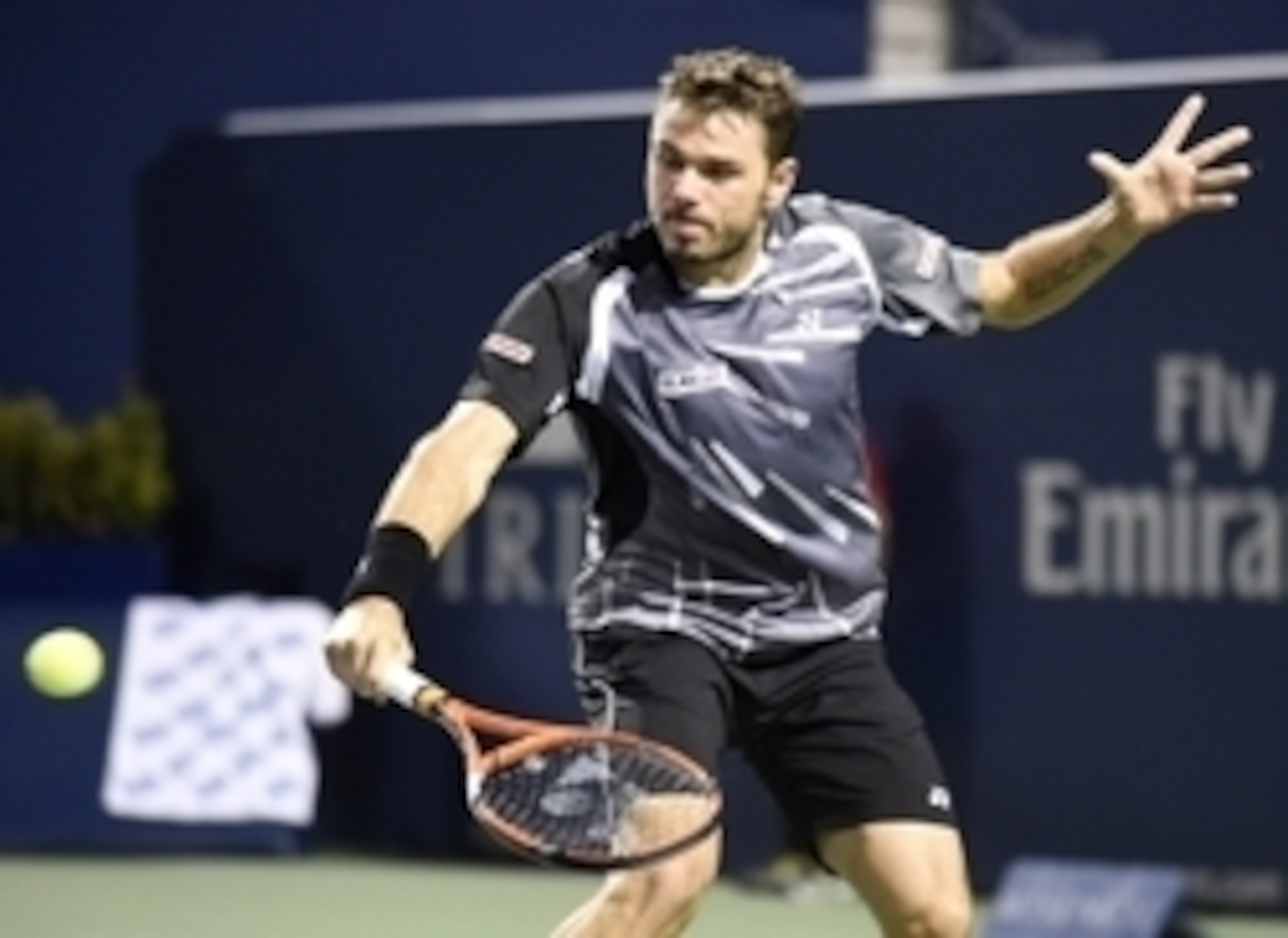 Aug 5, 2014; Toronto, Ontario Canada; Stan Wawrinka  of Switzerland plays a backhand against Benoit Paire of France on day two of the Rogers Cup tennis tournament at Rexall Centre. Mandatory Credit: Peter Llewellyn-USA TODAY Sports