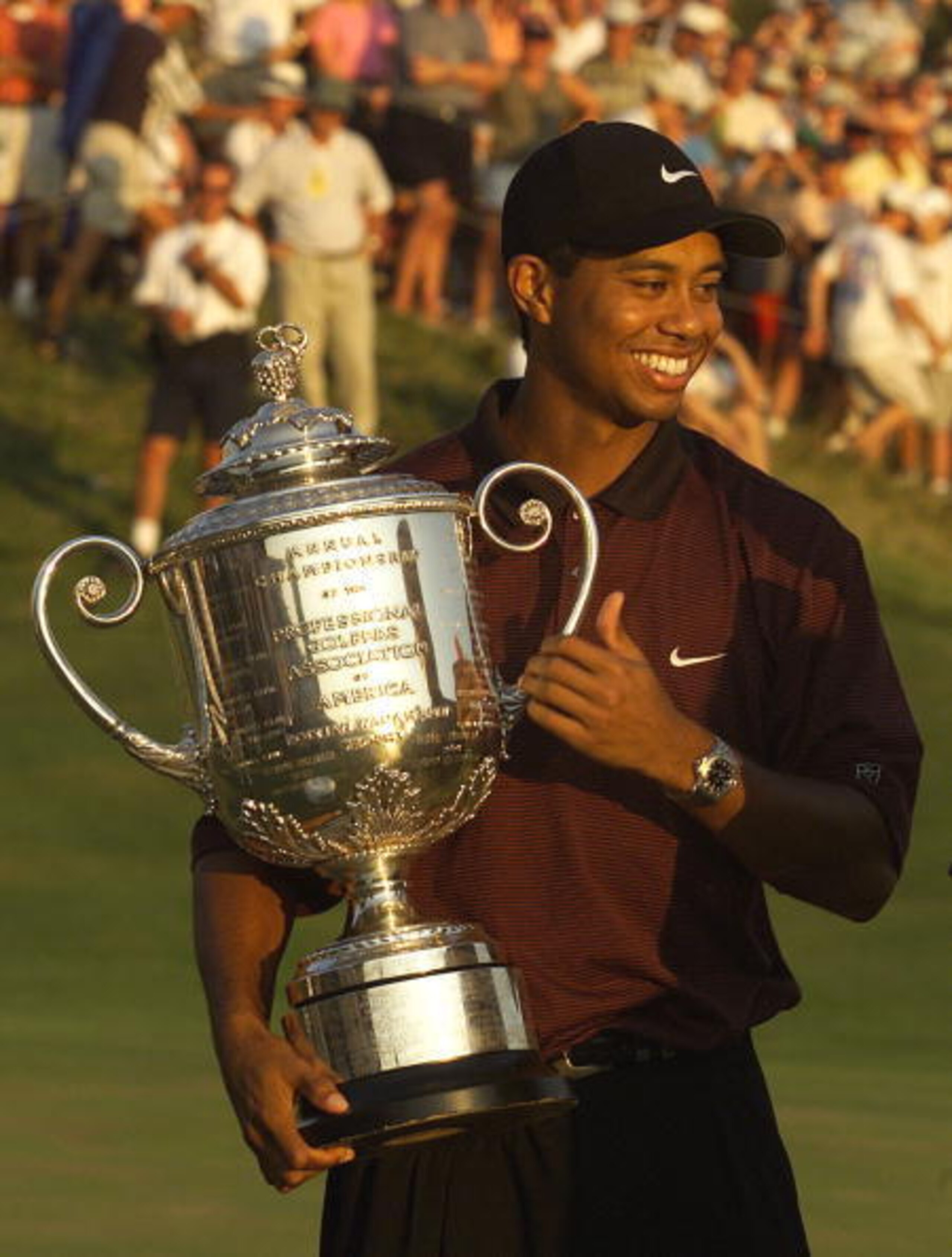 Tiger Woods grips trophy at 2000 PGA Championship. Tiger Woods grips trophy at 2000 PGA Championship.