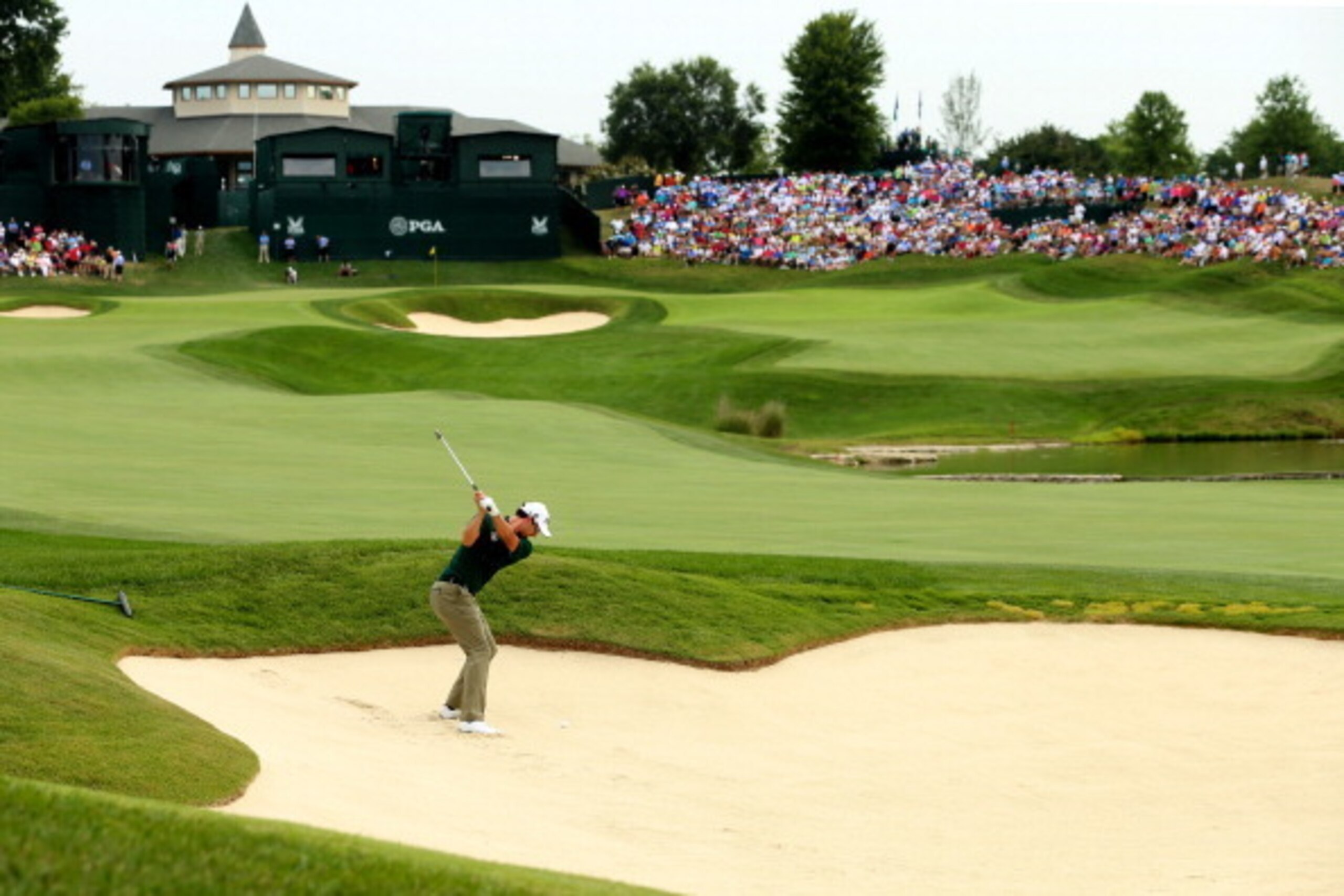 Adam Scott takes on a difficult bunker shot.