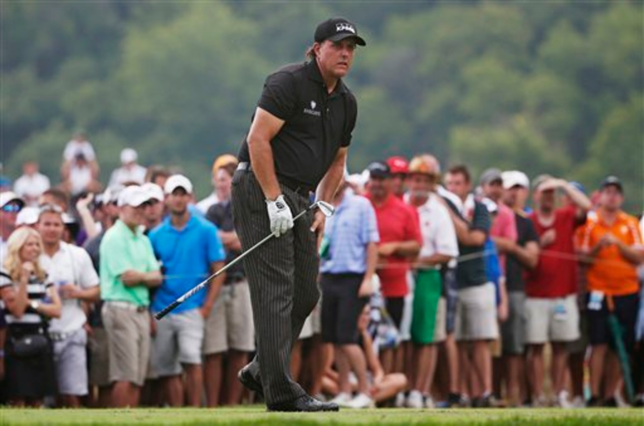 Phil Mickelson anxiously watches a putt Sunday.