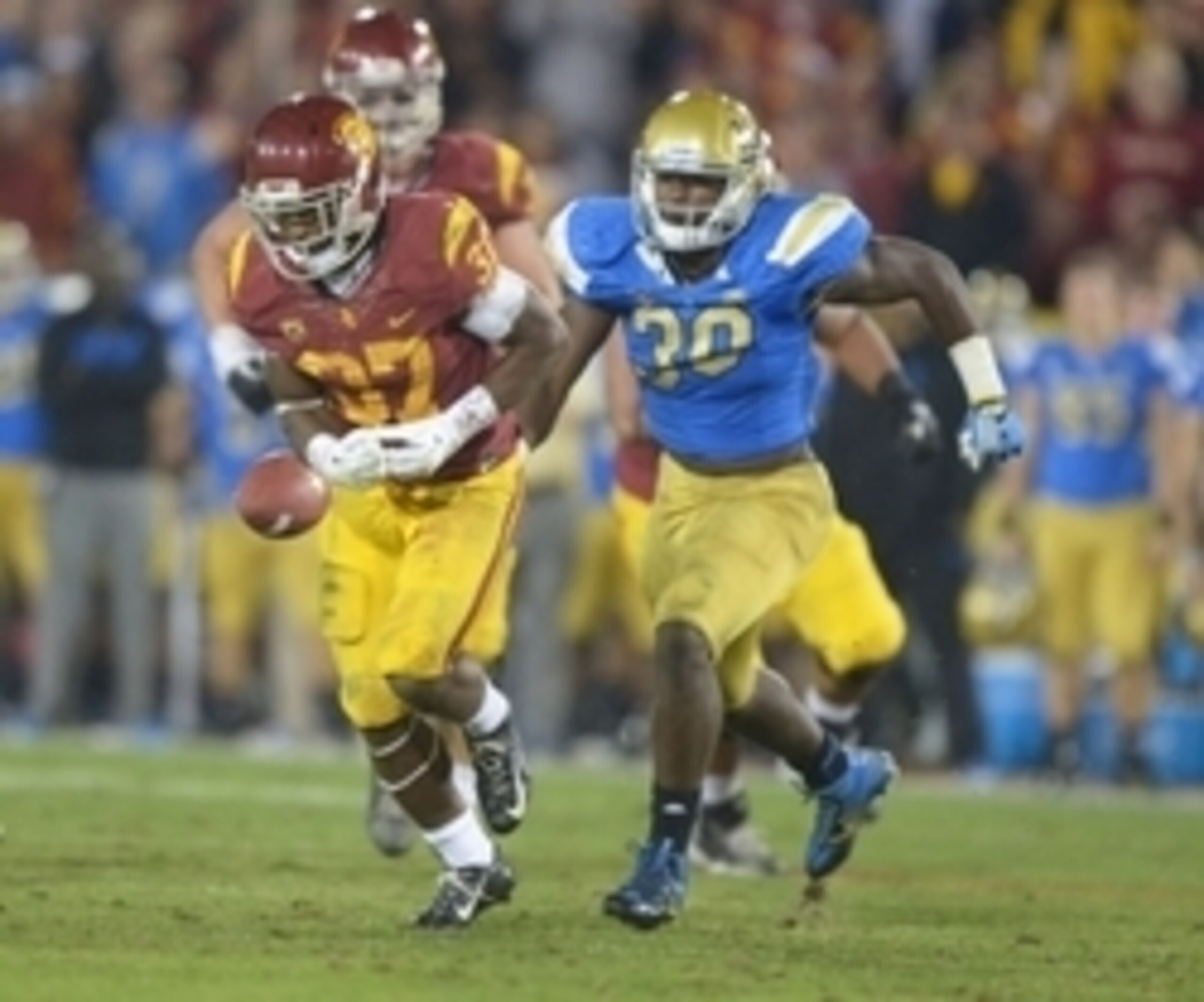 Nov 30, 2013; Los Angeles, CA, USA; Southern California Trojans tailback Javorious Allen (37) fumbles the ball as UCLA Bruins linebacker Myles Jack (30) defends at Los Angeles Memorial Coliseum. Mandatory Credit: Kirby Lee-USA TODAY Sports