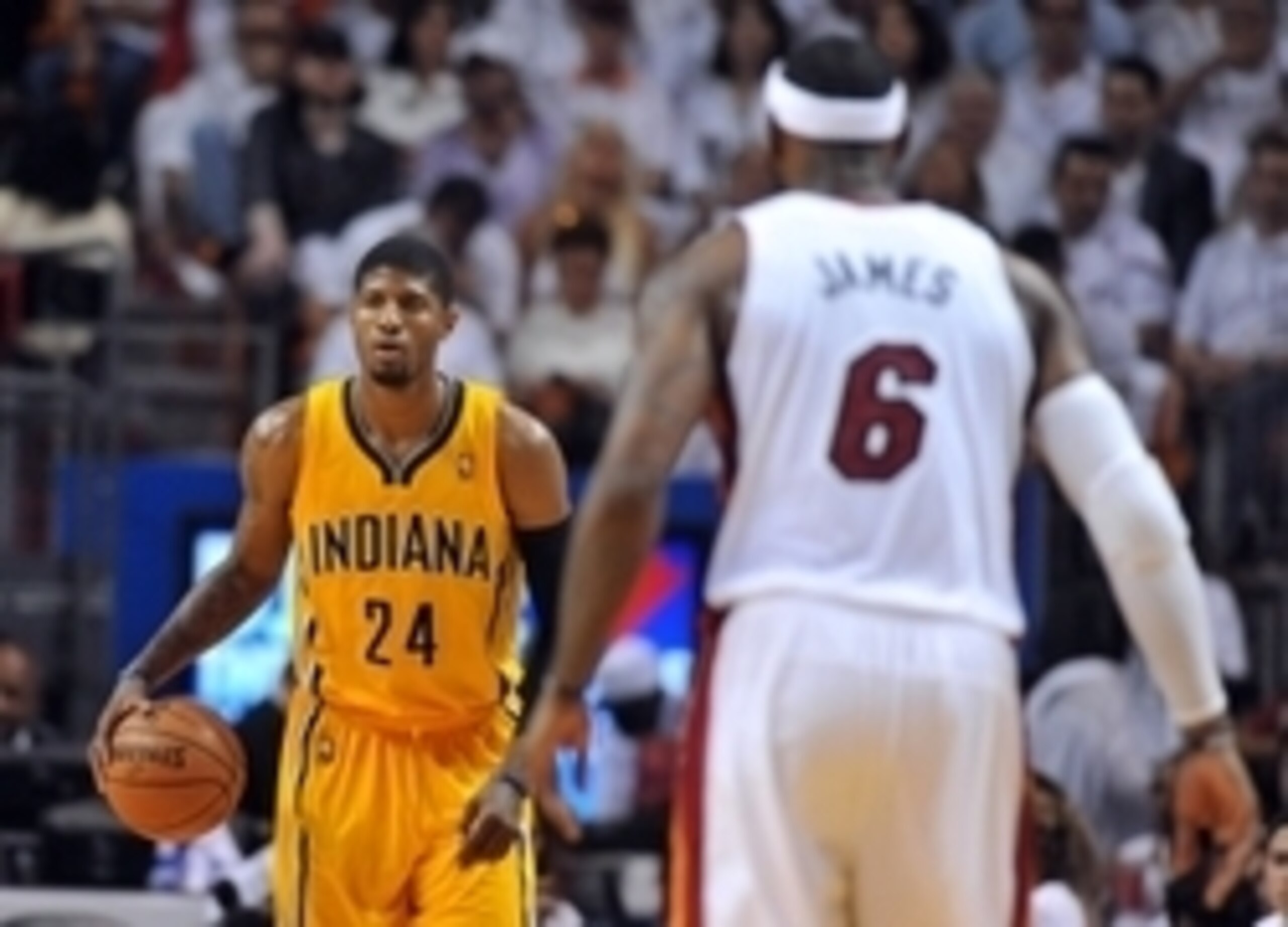 May 30, 2014; Miami, FL, USA; Indiana Pacers forward Paul George (24) dribbles as Miami Heat forward LeBron James (6) defend in game six of the Eastern Conference Finals of the 2014 NBA Playoffs at American Airlines Arena. Mandatory Credit: Steve Mitchell