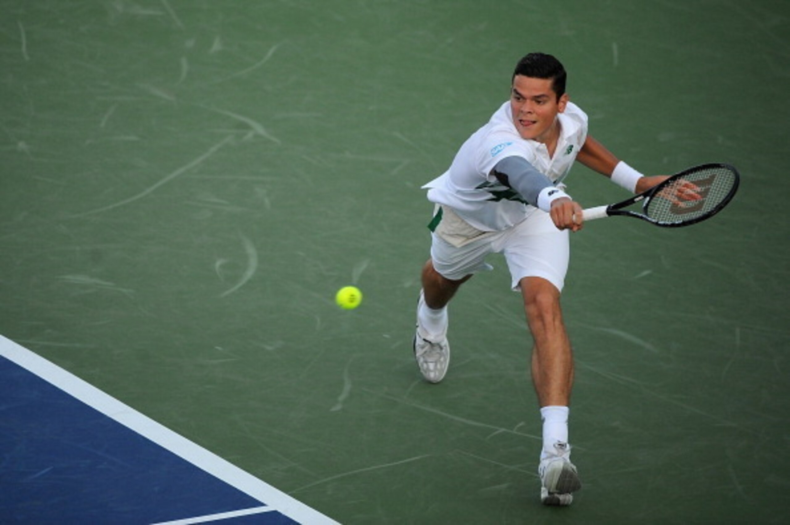 Milos Raonic reaches to make a play on the ball during his opening match in Cincinnati.