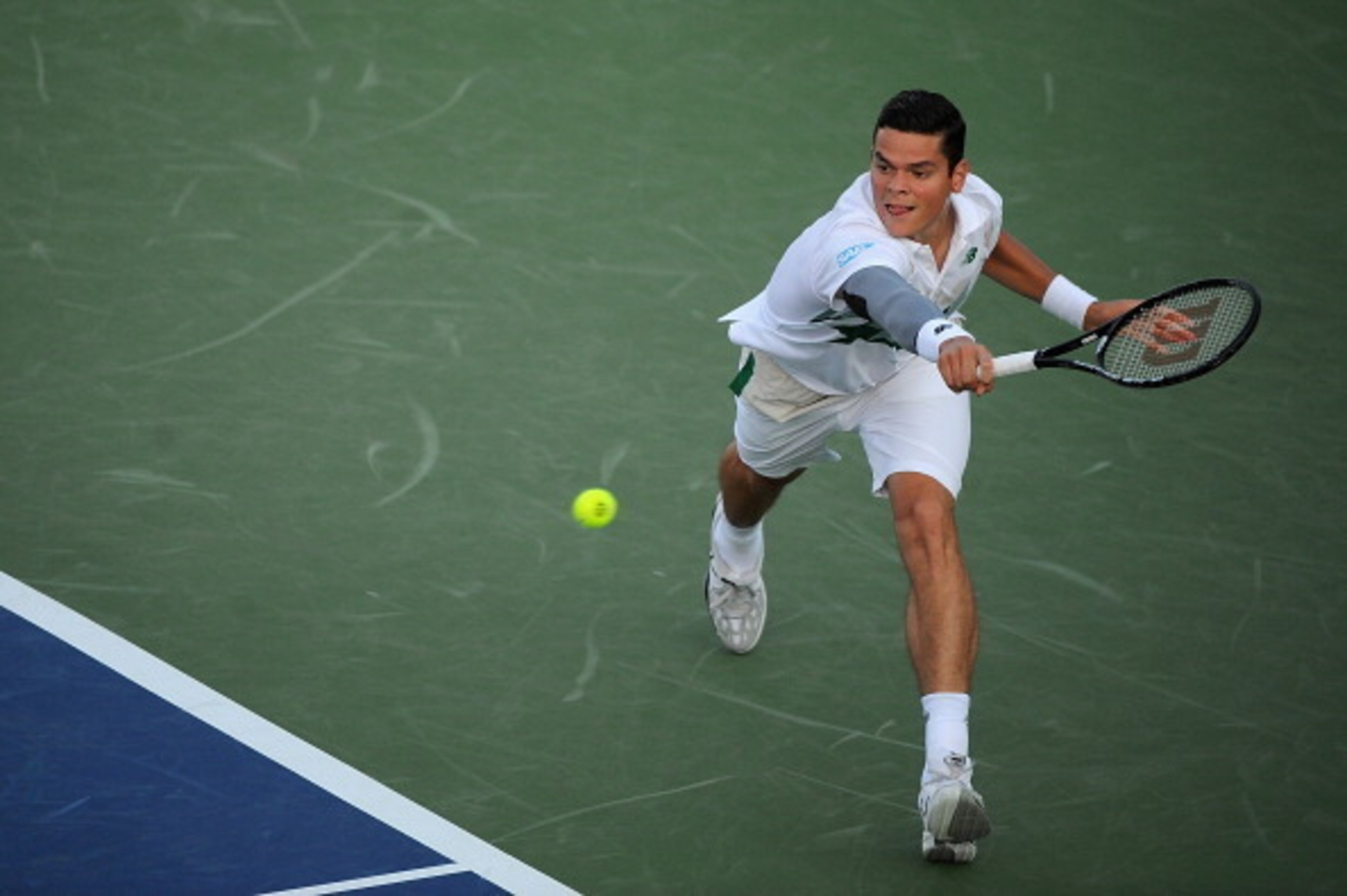 Milos Raonic reaches to make a play on the ball during his opening match in Cincinnati.