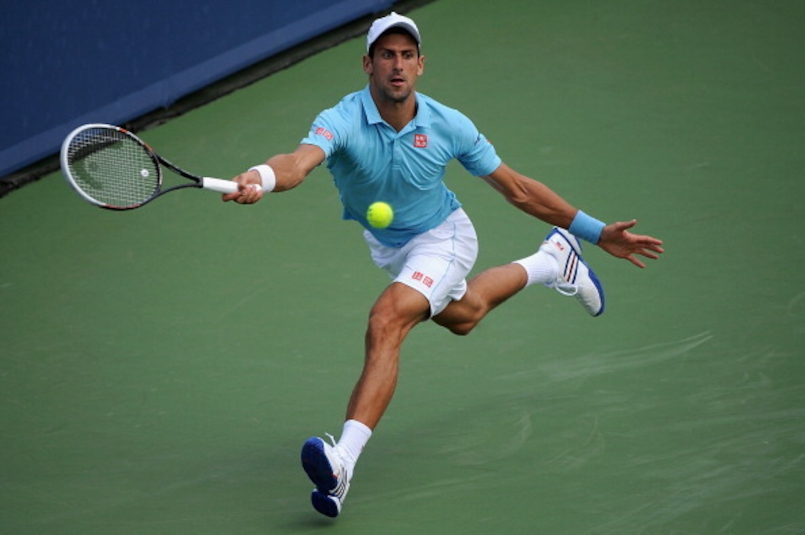 Novak Djokovic leaps toward a forehand during a match in Cincinnati.