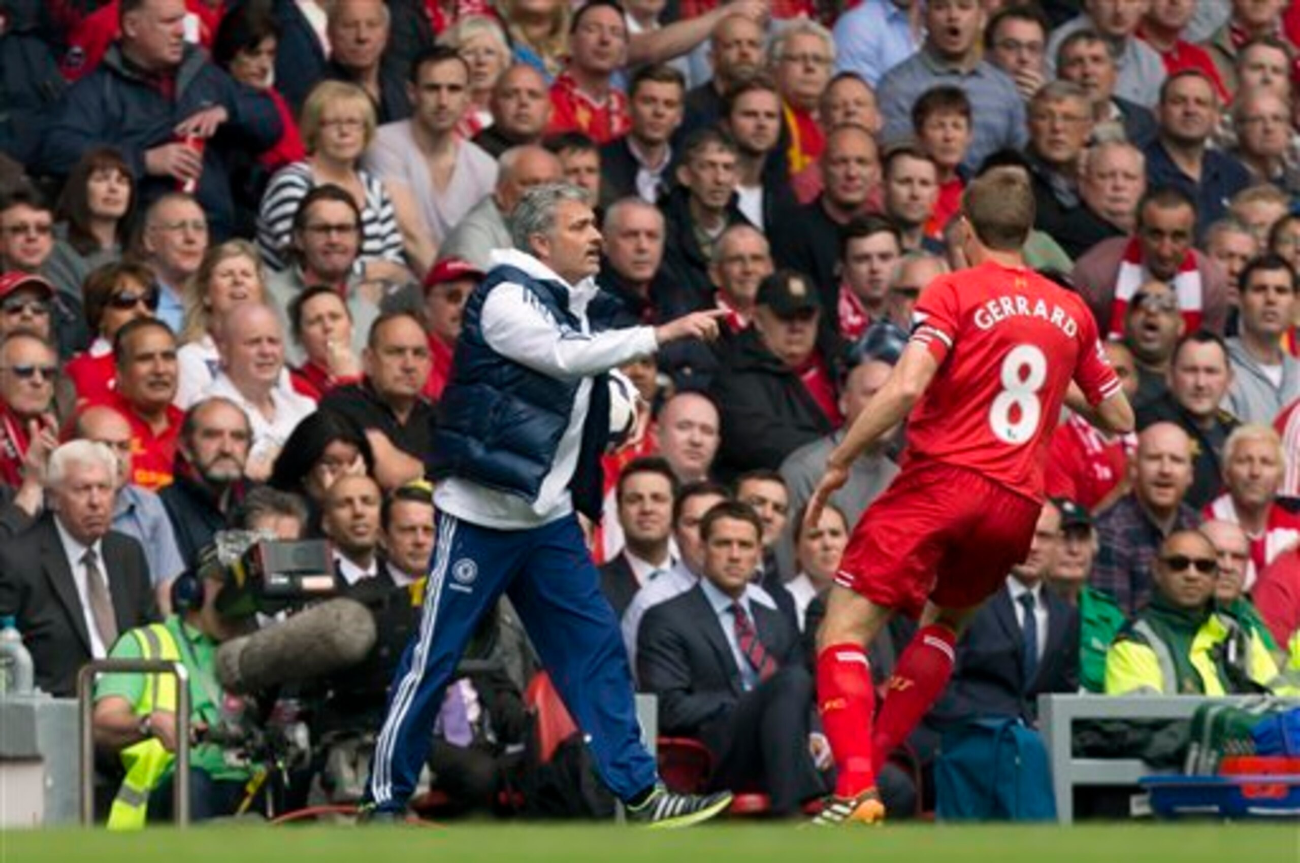 Chelsea's manager Jose Mourinho, left, keeps the ball from Liverpool's Steven Gerrard during their English Premier League soccer match at Anfield Stadium, Liverpool, England, Sunday April 27, 2014. (AP Photo/Jon Super)