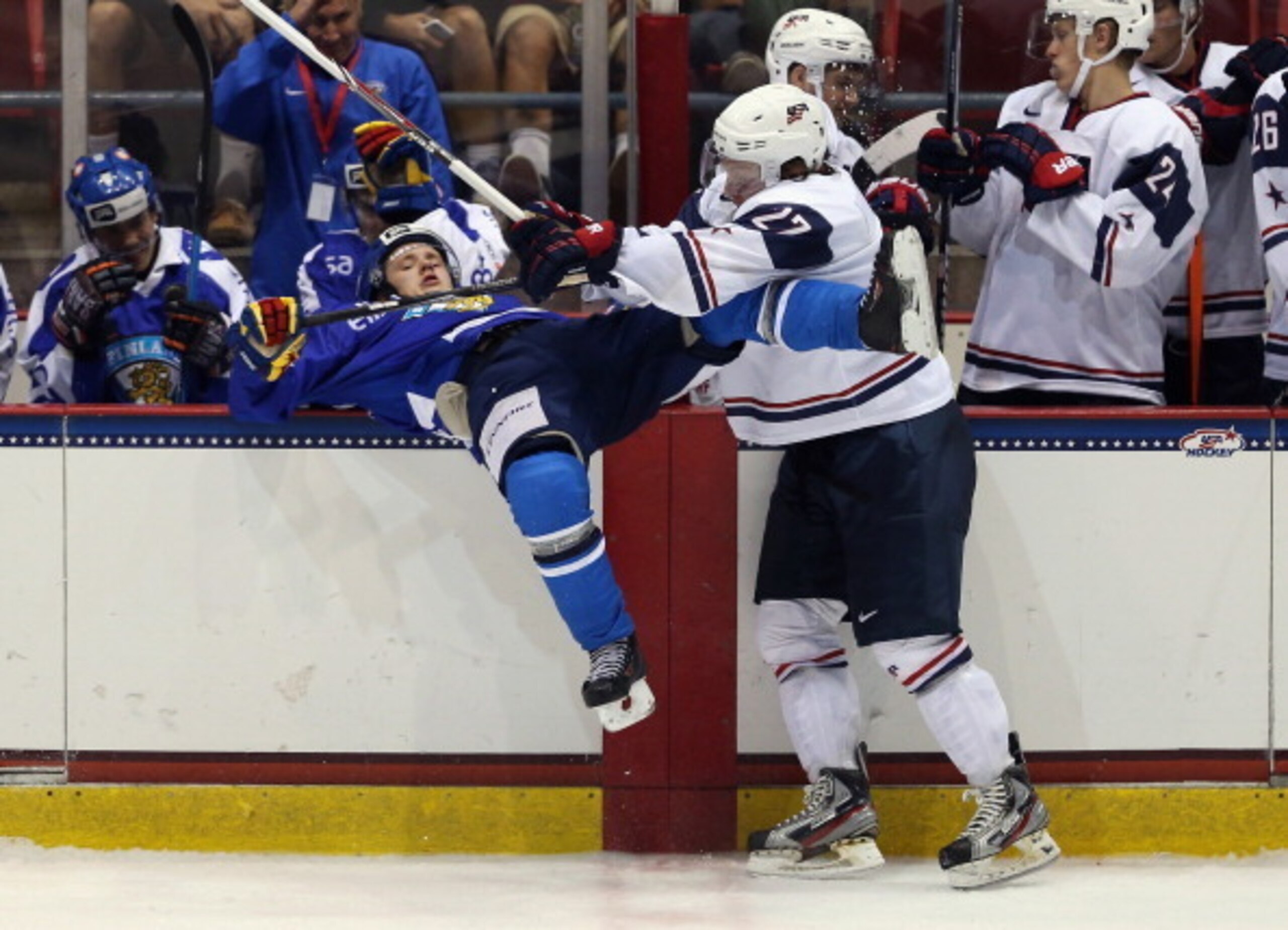 LAKE PLACID, NY - AUGUST 08: Aleksi Mustonen #10 of Team Finland is hit by Adam Erne #27 of Team USA during the 2013 USA Hockey Junior Evaluation Camp at the Lake Placid Olympic Center on August 8, 2013 in Lake Placid, New York. Team USA defeated Team Fin
