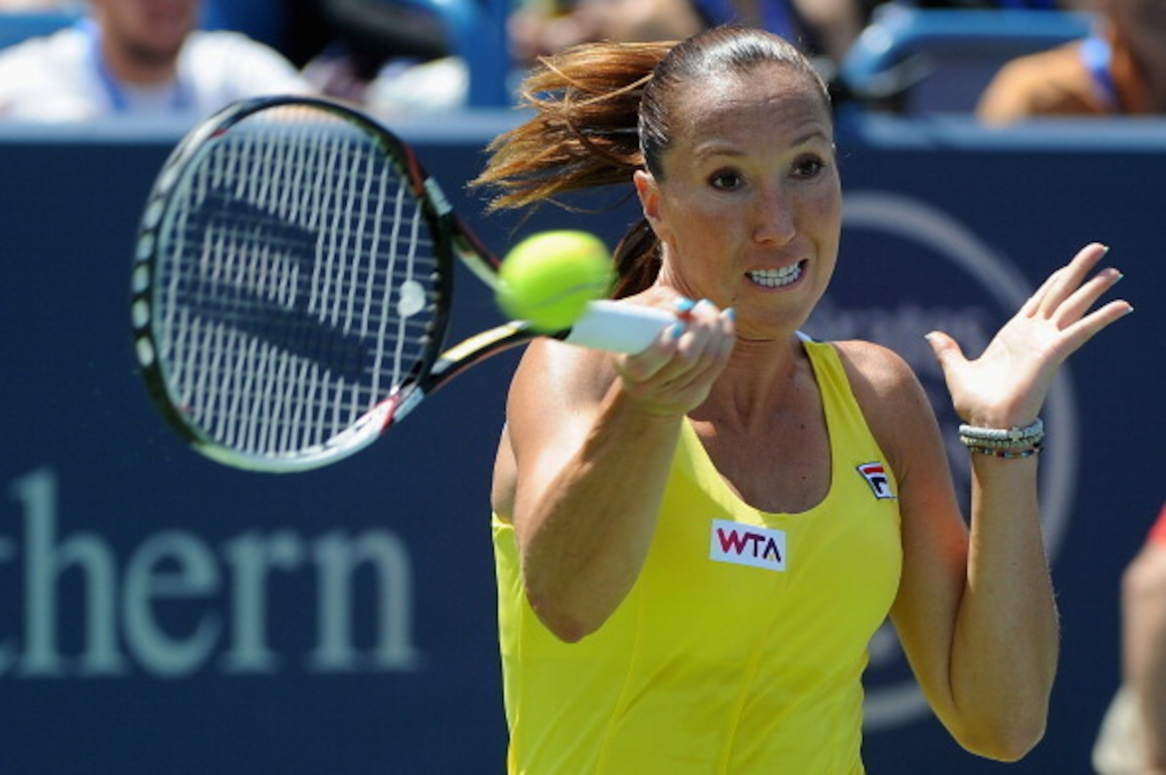 CINCINNATI, OH - AUGUST 15: Jelena Jankovic of Serbia returns to Serena Williams during a match on day 7 of the Western & Southern Open at the Linder Family Center on August 15, 2014 in Cincinnati, Ohio. (Photo by Jonathan Moore/Getty Images)