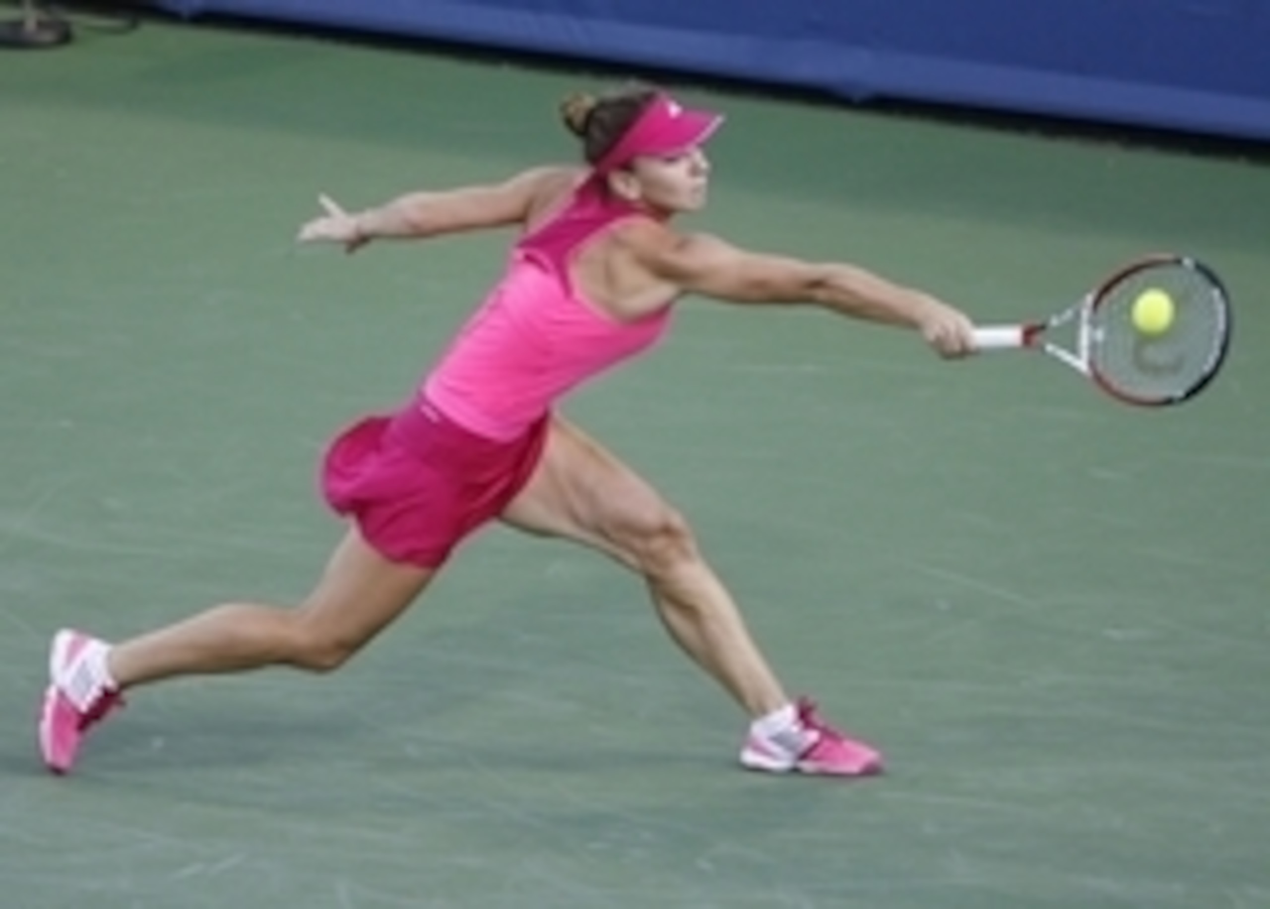 Simona Halep reaches to make a play on the ball during a match against Maria Sharapova at the Western & Southern Open in Cincinnati.