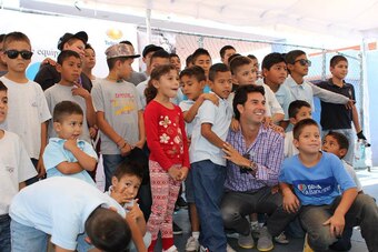 Perez visiting a children's home.