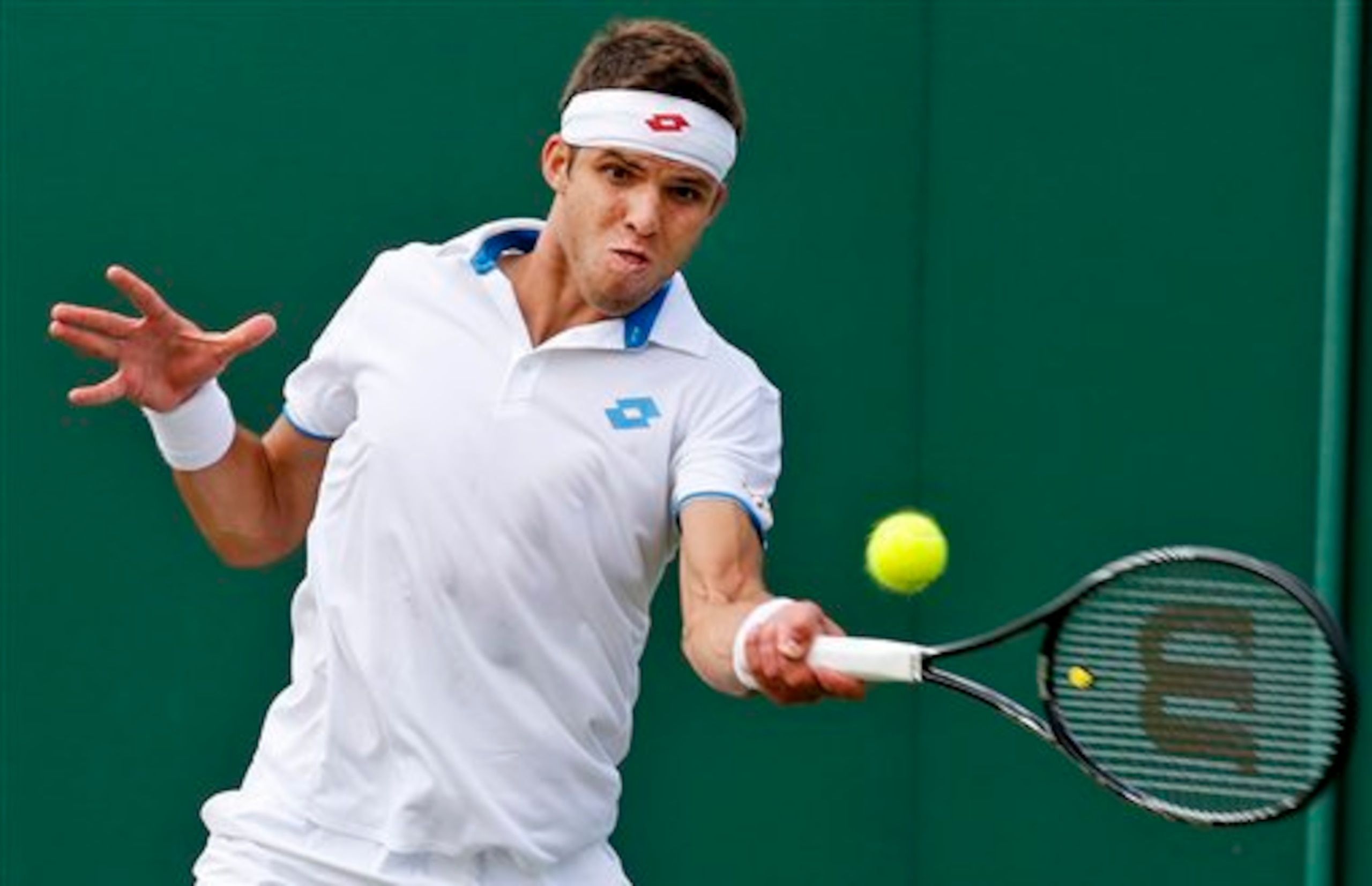Jiri Vesely hits a forehand during a 2014 Wimbledon match.