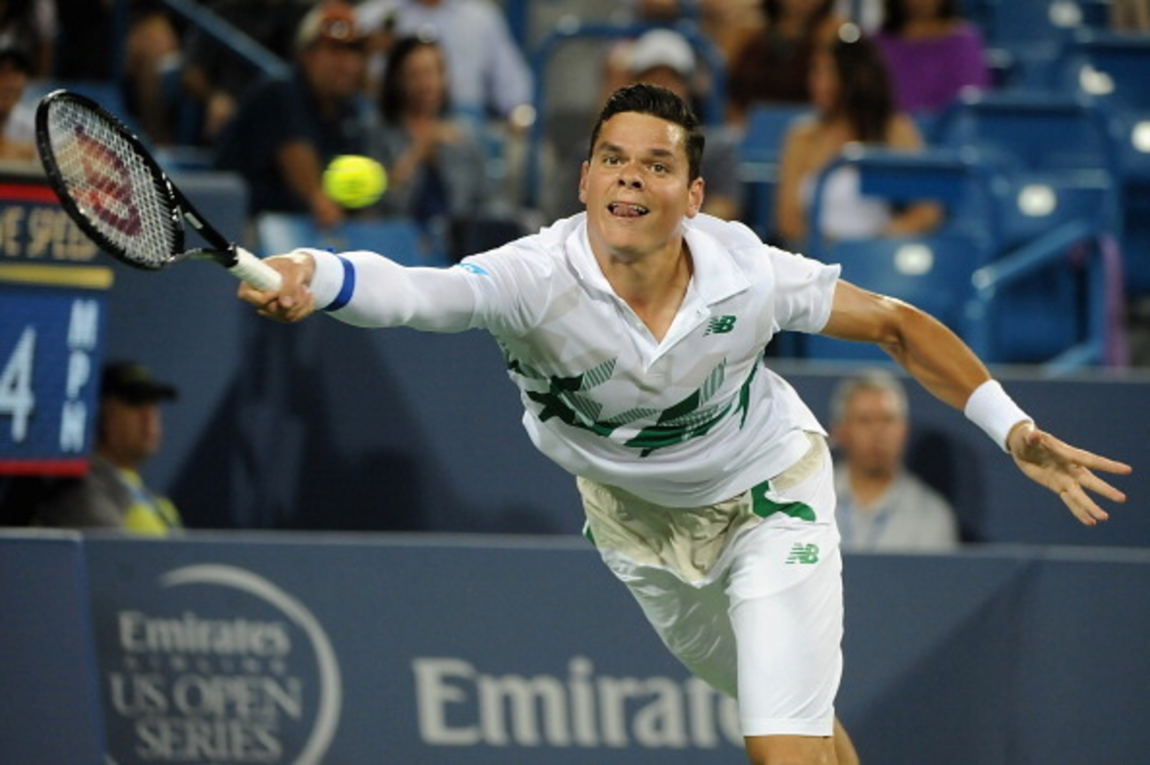 Milos Raonic reaches to make a play on the ball during a match against Roger Federer in Cincinnati. Milos Raonic reaches to make a play on the ball during a match against Roger Federer in Cincinnati.