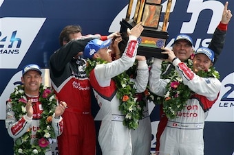 Lotterer and his team-mates lifting the 2014 Le Mans trophy.
