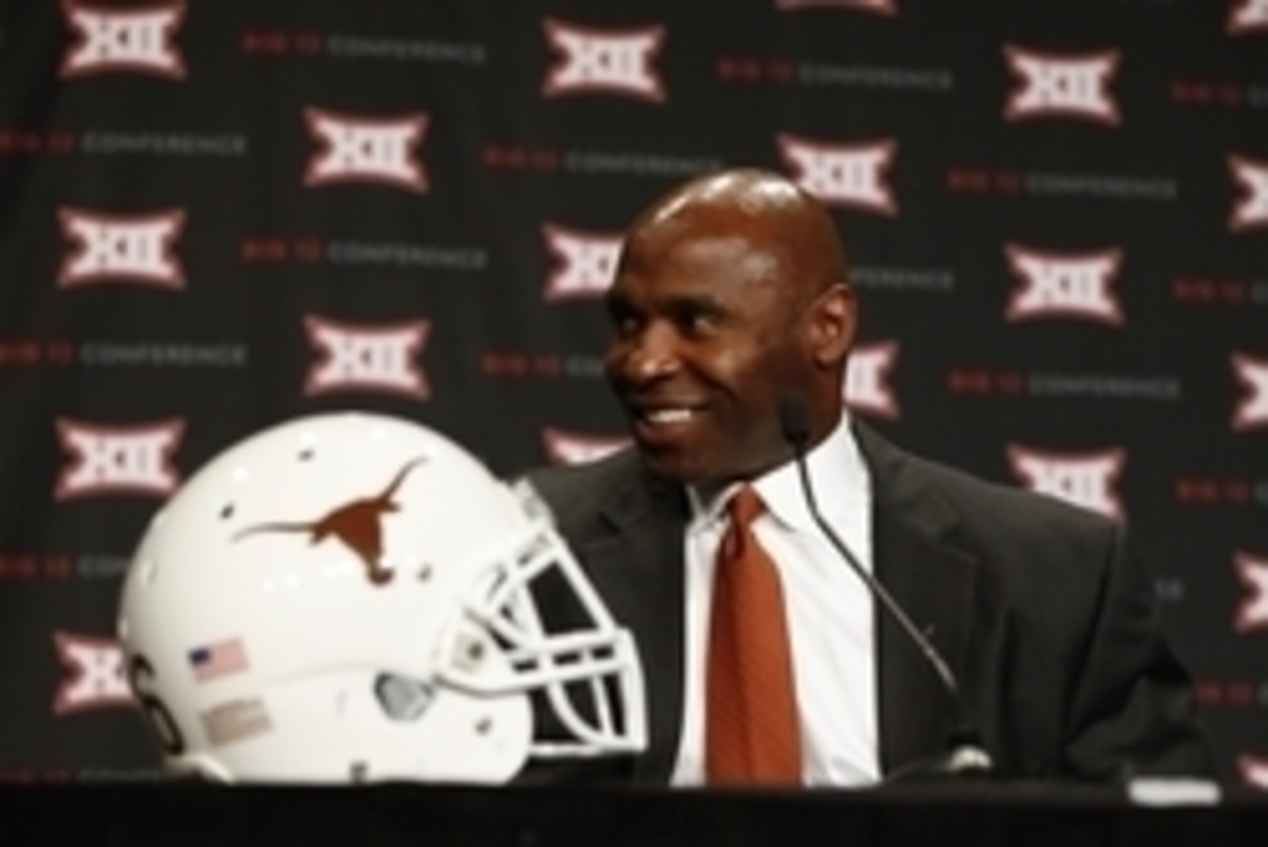 Hired to instill a new attitude within the program, Charlie Strong will coach the Longhorns to a major upset in 2014.